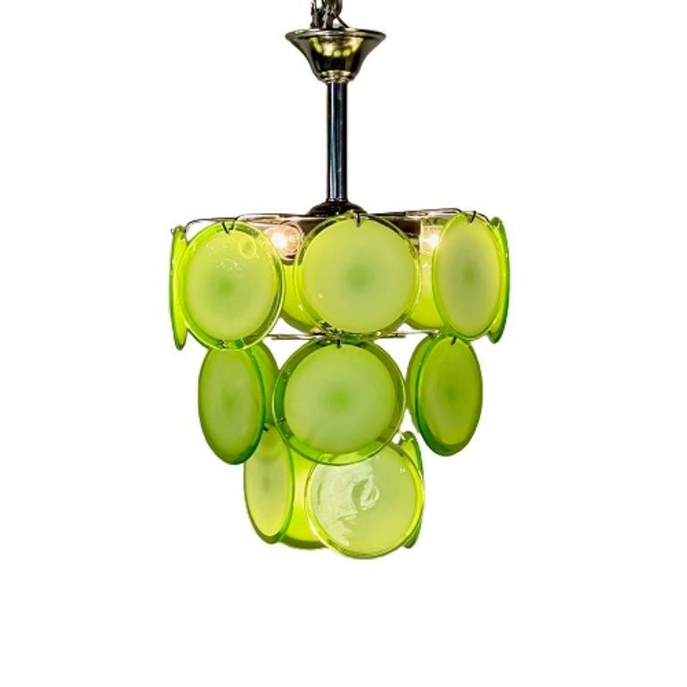 Pair of Mid-Century Modern Style Small Green Murano Glass Disk Chandeliers
A pair of mid-century modern Murano glass chandeliers in a classic suspended disks configuration. Each fixture has 18 pale, translucent green over white Murano glass disks