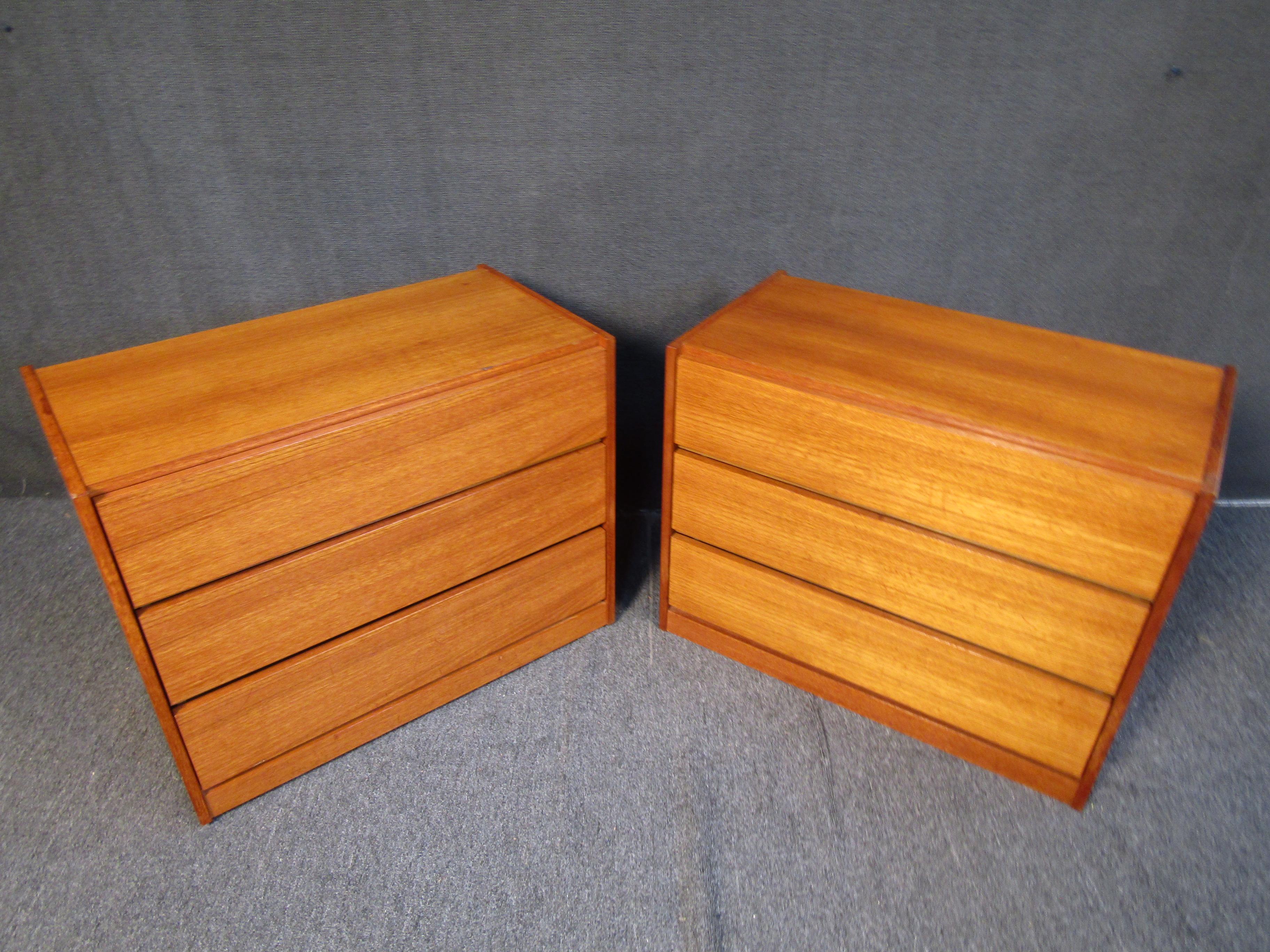 This pair of teak dressers features a minimal design with three large drawers. Please confirm item location with seller (NY/NJ).