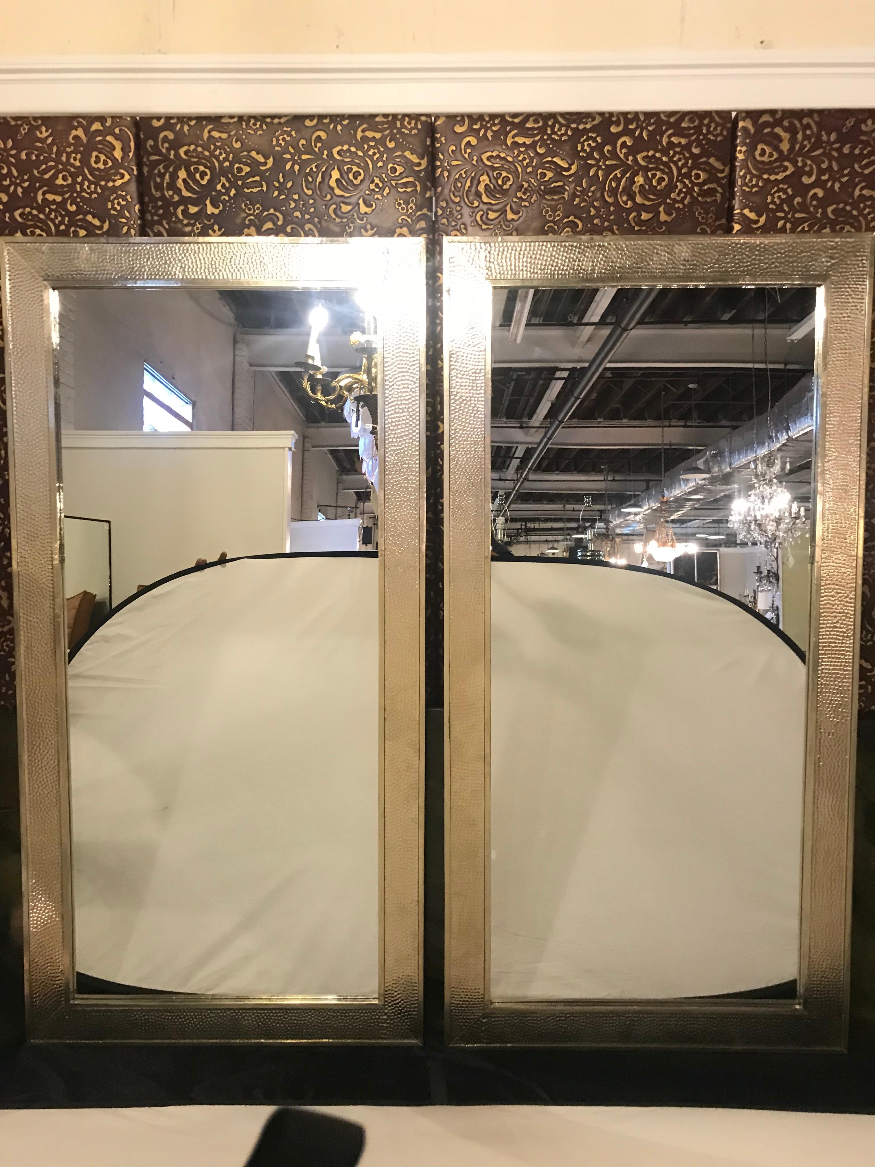 Pair of Mid-Century Modern Paul Evans style white brass wall/ floor or console mirrors. An elegant pair of monumental Mid-Century Modern wall or console mirrors featuring an all hammered style white brass frame. Can be used as wall or floor mirrors.