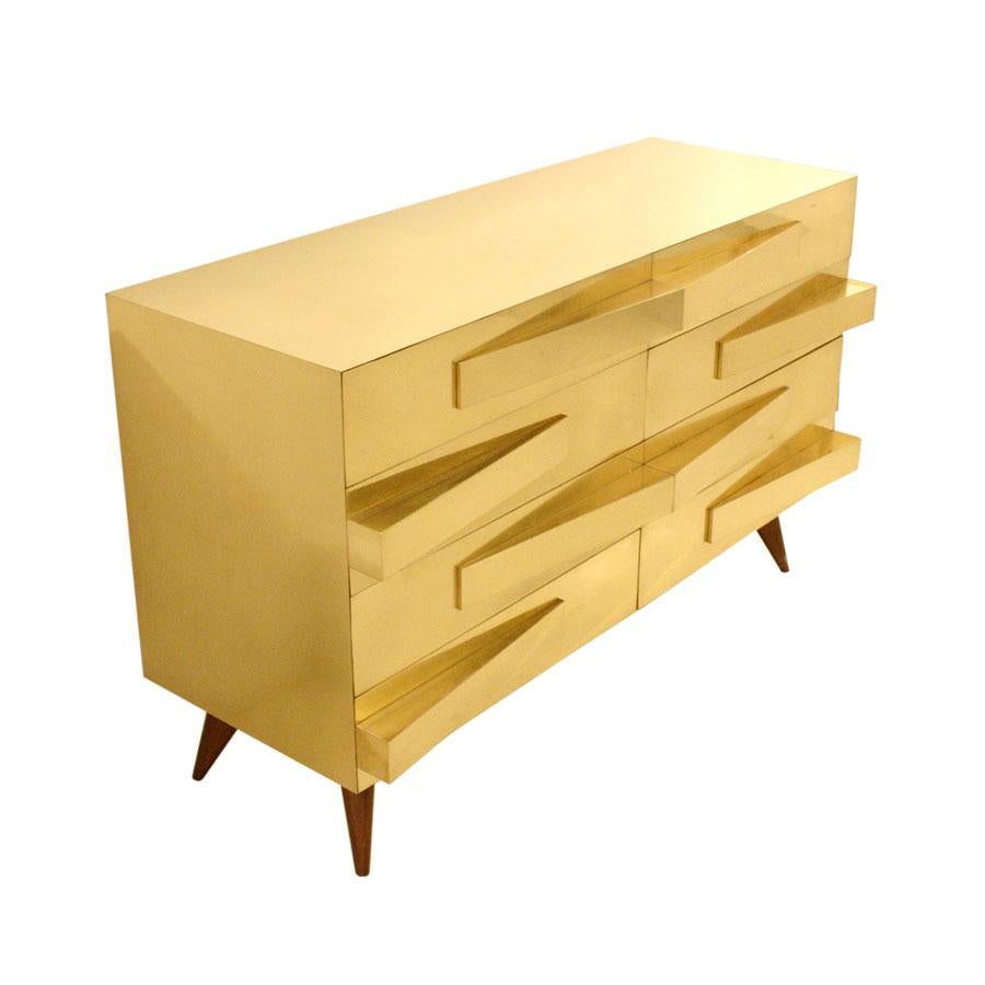 Pair of Mid-Century Modern style Italian commodes. Structure from the 1950s made of solid wood and covered in brass. Composed of eight drawers with geometric shapes handles.