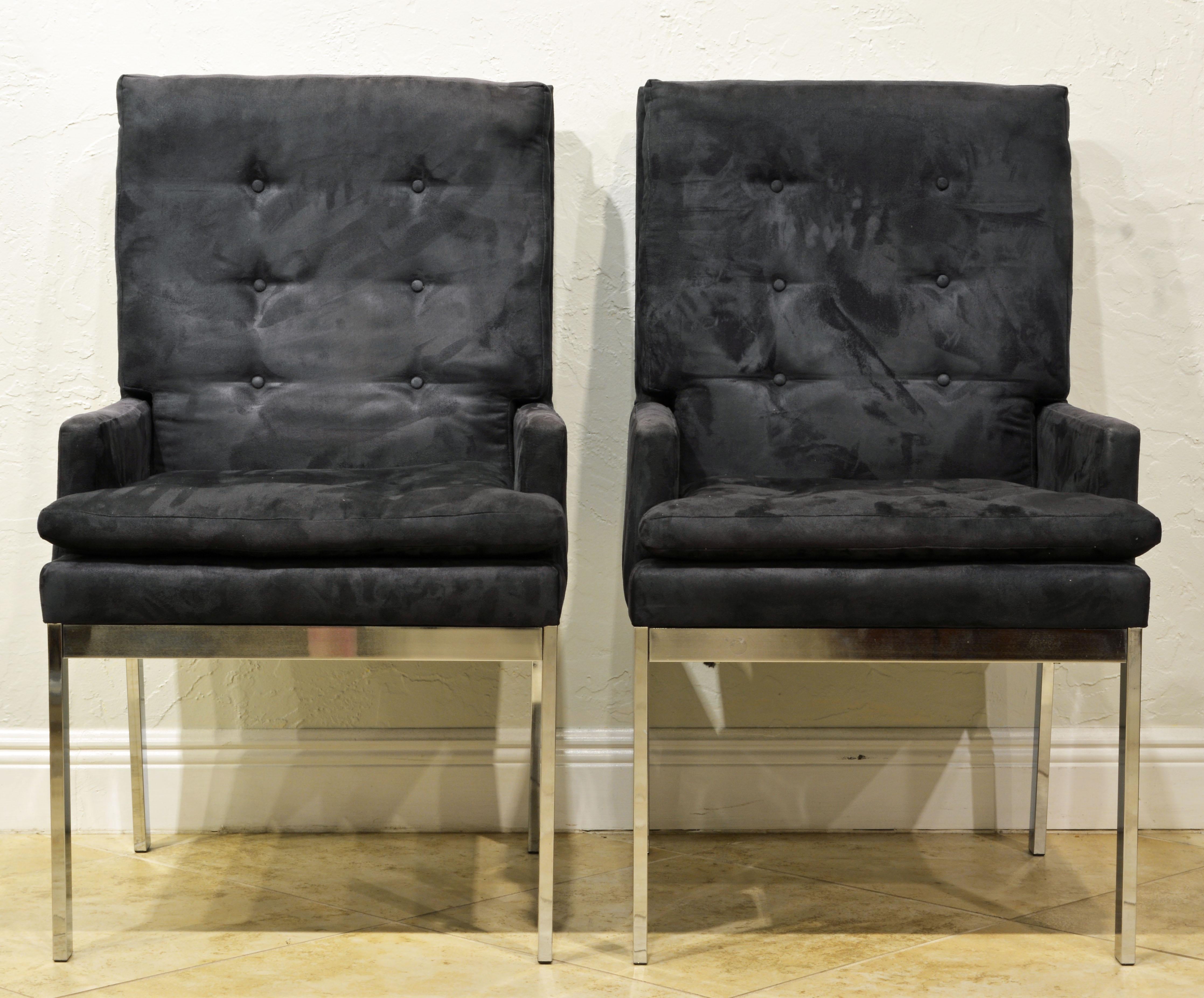 These armchairs or lounge chairs feature charcoal (with a slight bluish tint) tufted covered upholstery and elegant chrome frames and legs. A modern Classic.