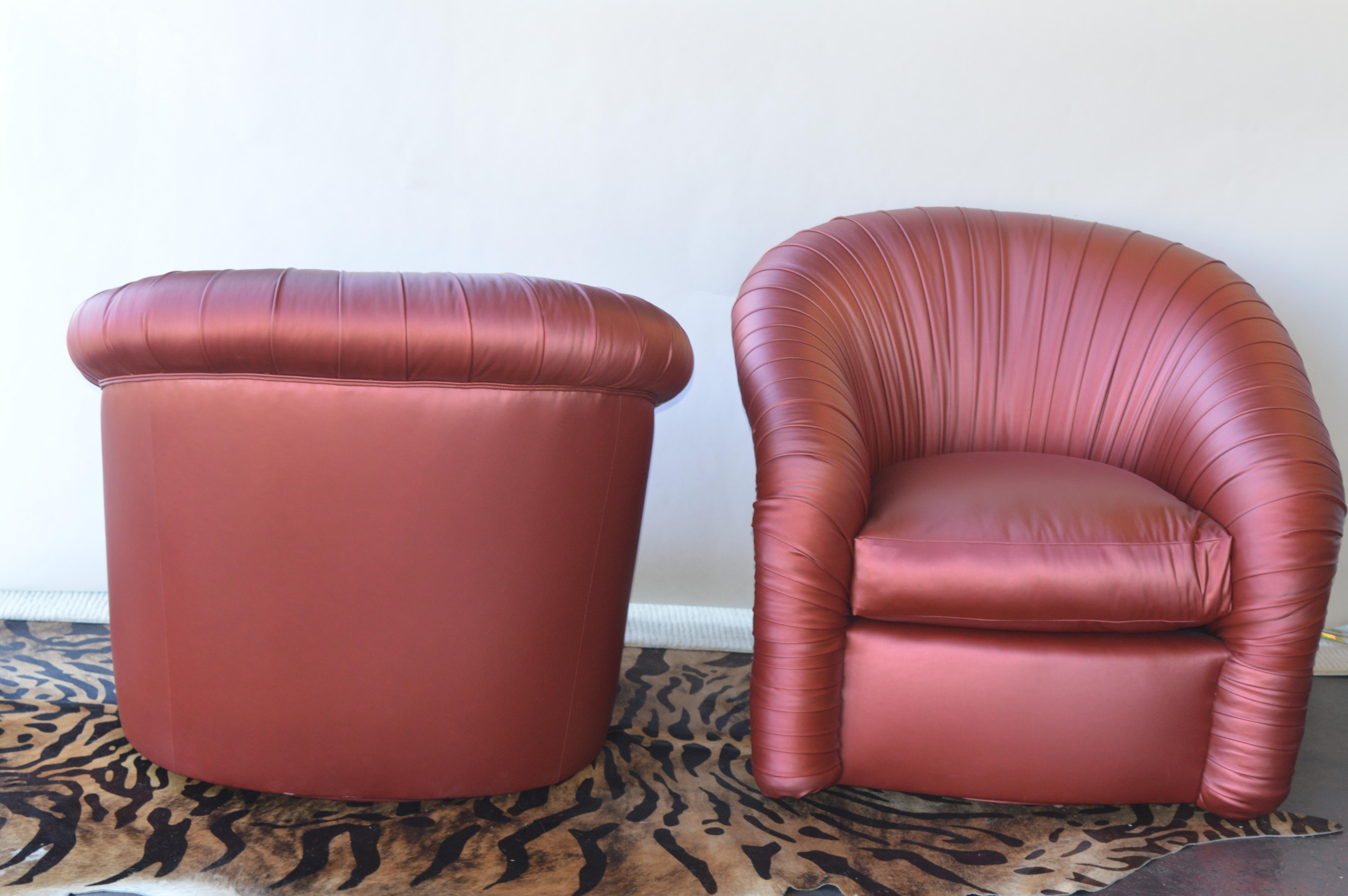Pair of swivel chairs in an iridescent red latex.