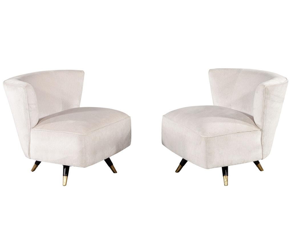 Pair of Mid-Century Modern swivel chairs. American, 1960's. Fully restored like new by the Carrocel artisans in a luxuriously soft fabric material. Featuring swivel mechanism and sleek metal legs capped in brass. Price includes complimentary curb