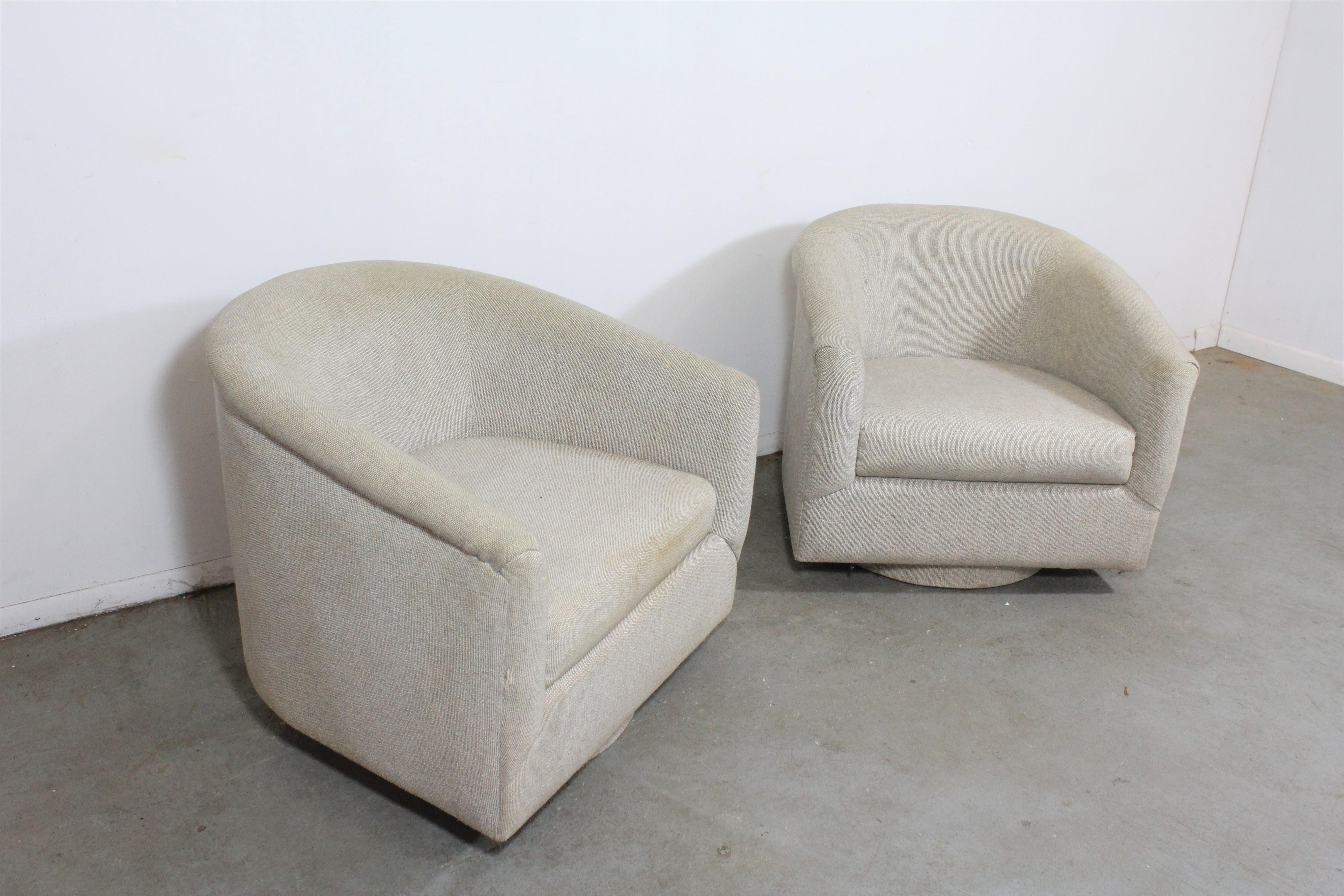 Pair of Mid-Century Modern Swivel club chairs 

What a find. Offered is a pair of swivel chairs on platform bases. The upholstery is in usable condition and it is structurally sound. The upholstery has stains throughout both chairs as well as on