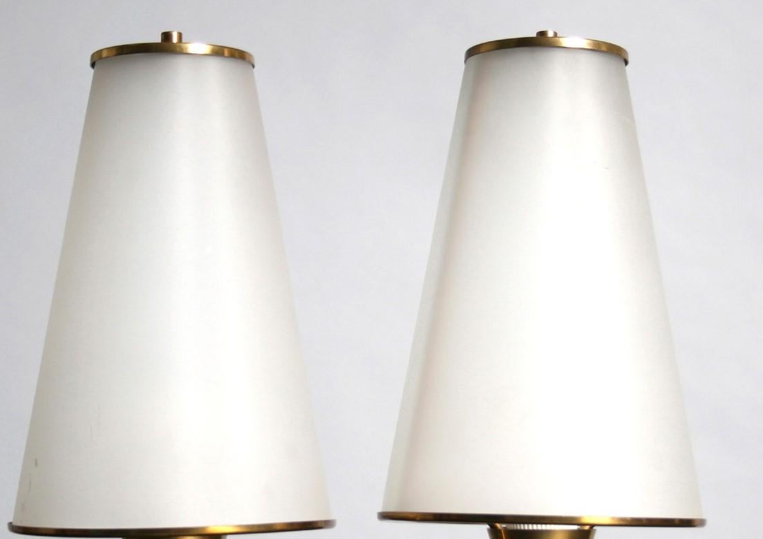 Pair of high quality table lamps attributed to the well known Italian designer Osvaldo Borsani. These lamps are unusual in that they are styled in the form of an oil lamp or Aladdin's lamp. The circle details on the base are a signature design for