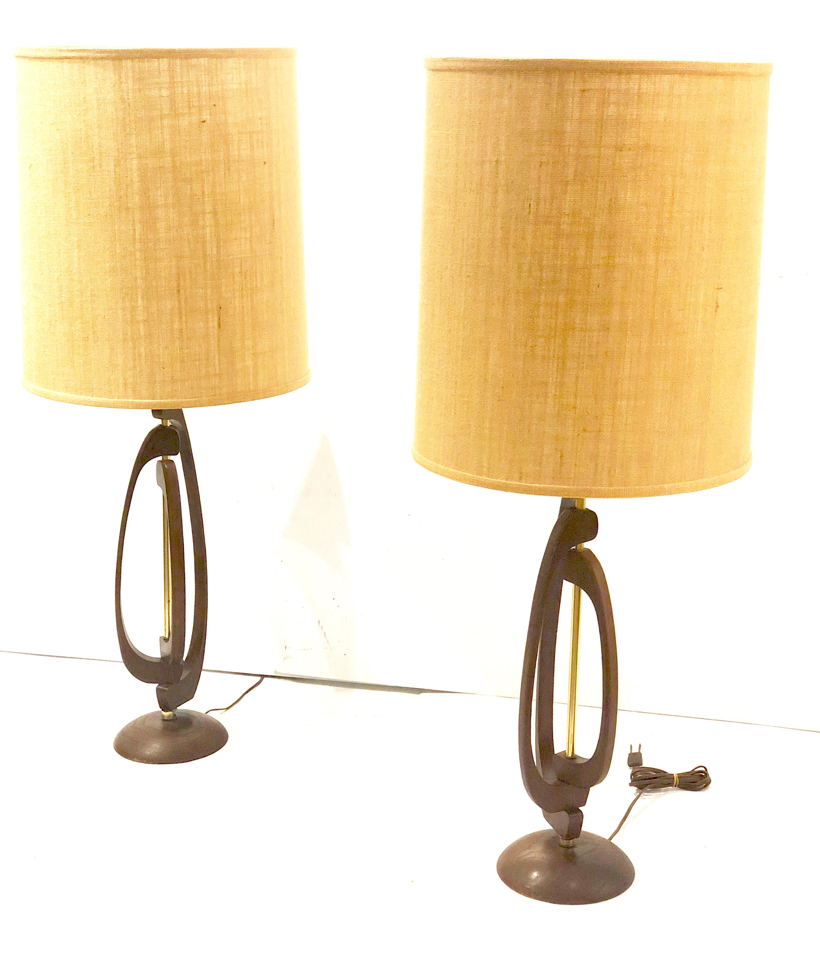 Nice original pair of 1950s American Mid-Century Modern Atomic Age table lamps, by Modeline The lampshades are the original but we have remake them, they are in very nice condition the bases have the original finish in walnut we oil them and cleaned