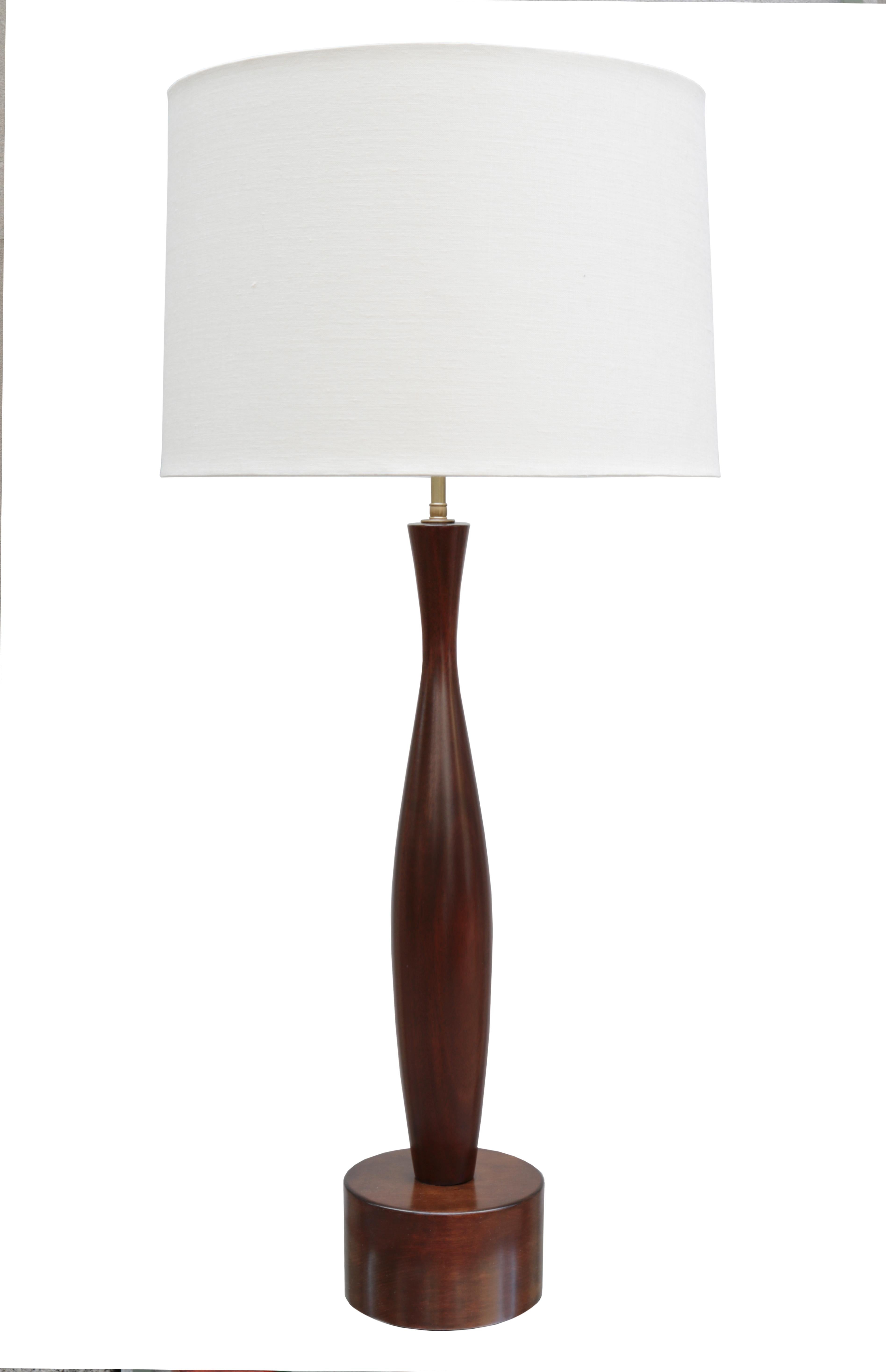 A pair of Mid-Century Modernist table lamps. 
Sculptural forms crafted in mahogany.
