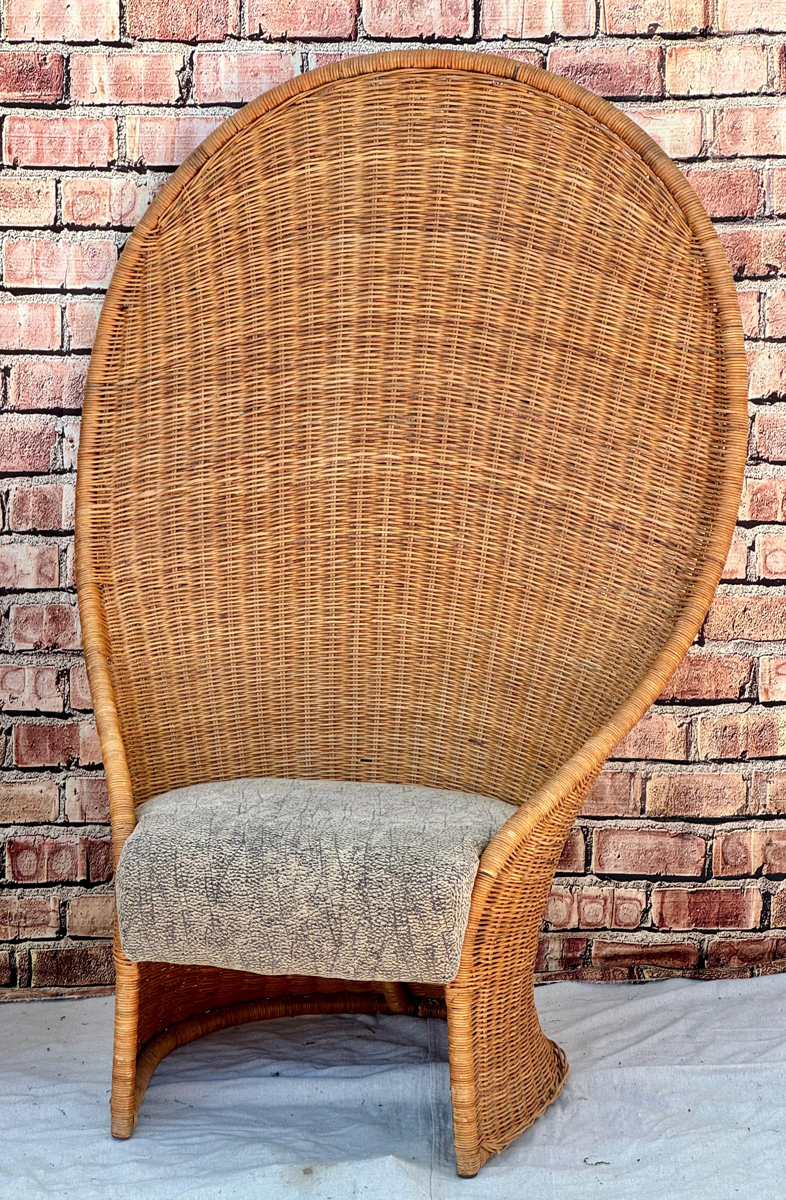 Pair of mid-century modern tall rattan wicker peacock style chairs. Chairs feature the classic tall peacock style with a unique addition of original upholstered seats. Would look great in any outdoor enclosed area, as well as in an indoor boho chic