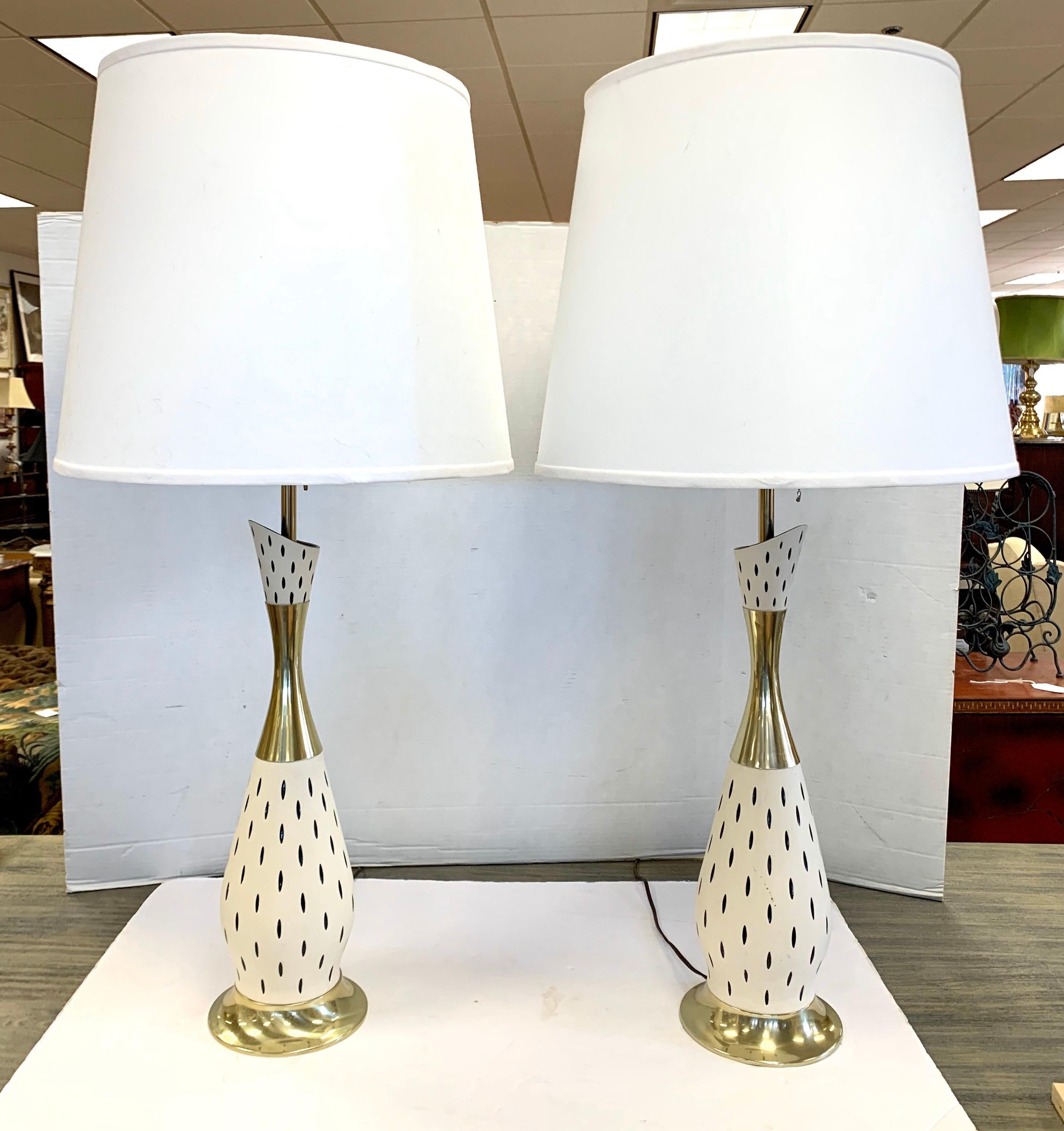 Made of brass and ceramic and colored with a gorgeous creamy off-white and black design, these lamps exude the iconic midcentury look that is so coveted. They have custom made shades that measure 19