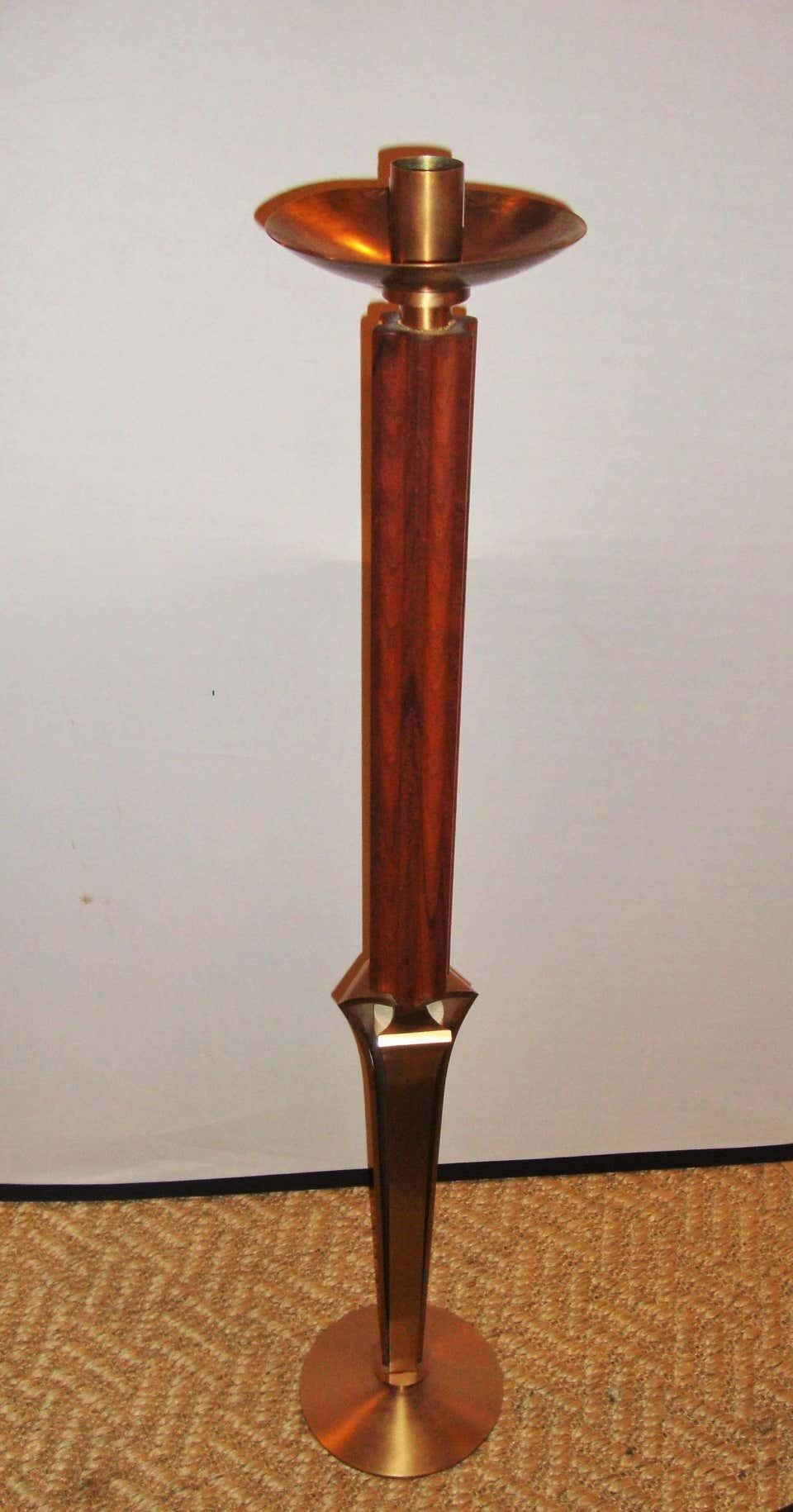 Pair of teak and brass standing 