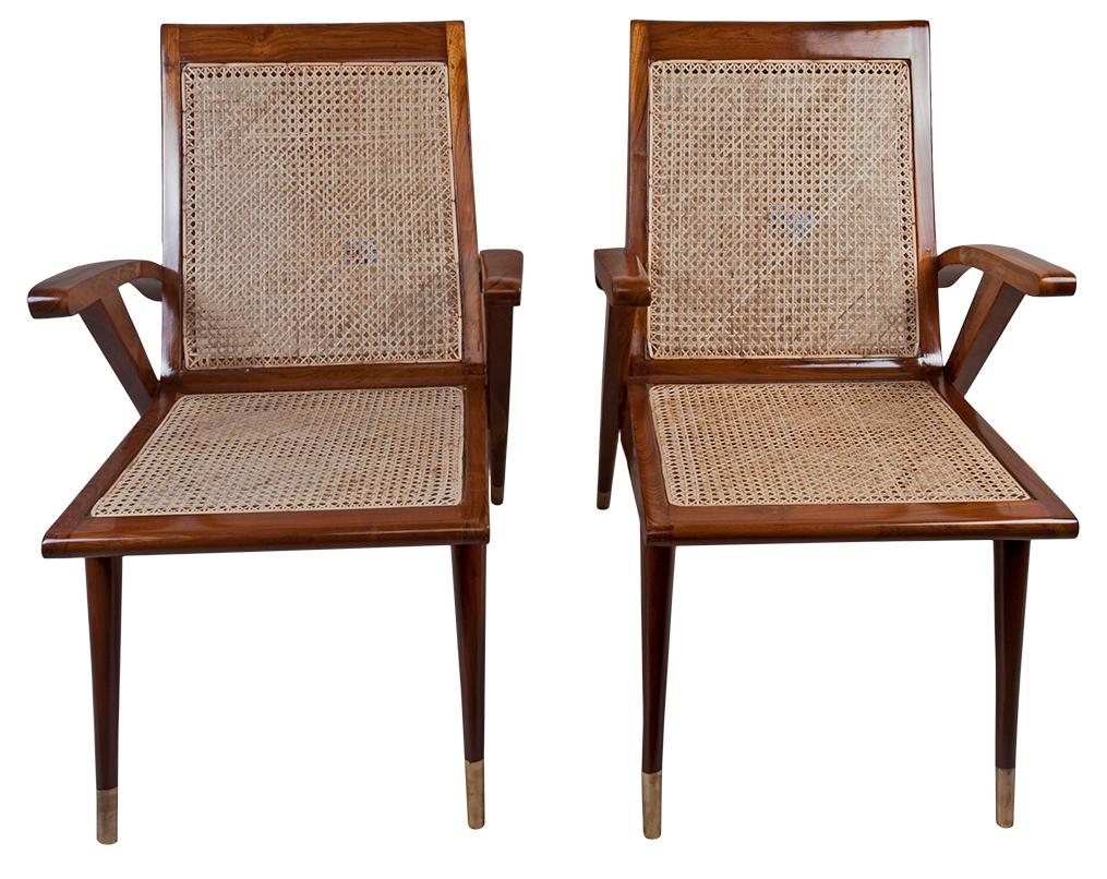 A pair of teak Mid-Century Modern side chairs with brass feet and lovely lines. Caning has been redone. Custom made off-white cushions of a silk and linen blend for both the seat and the back, to use or not as you like. Refinished, circa 1960s.
