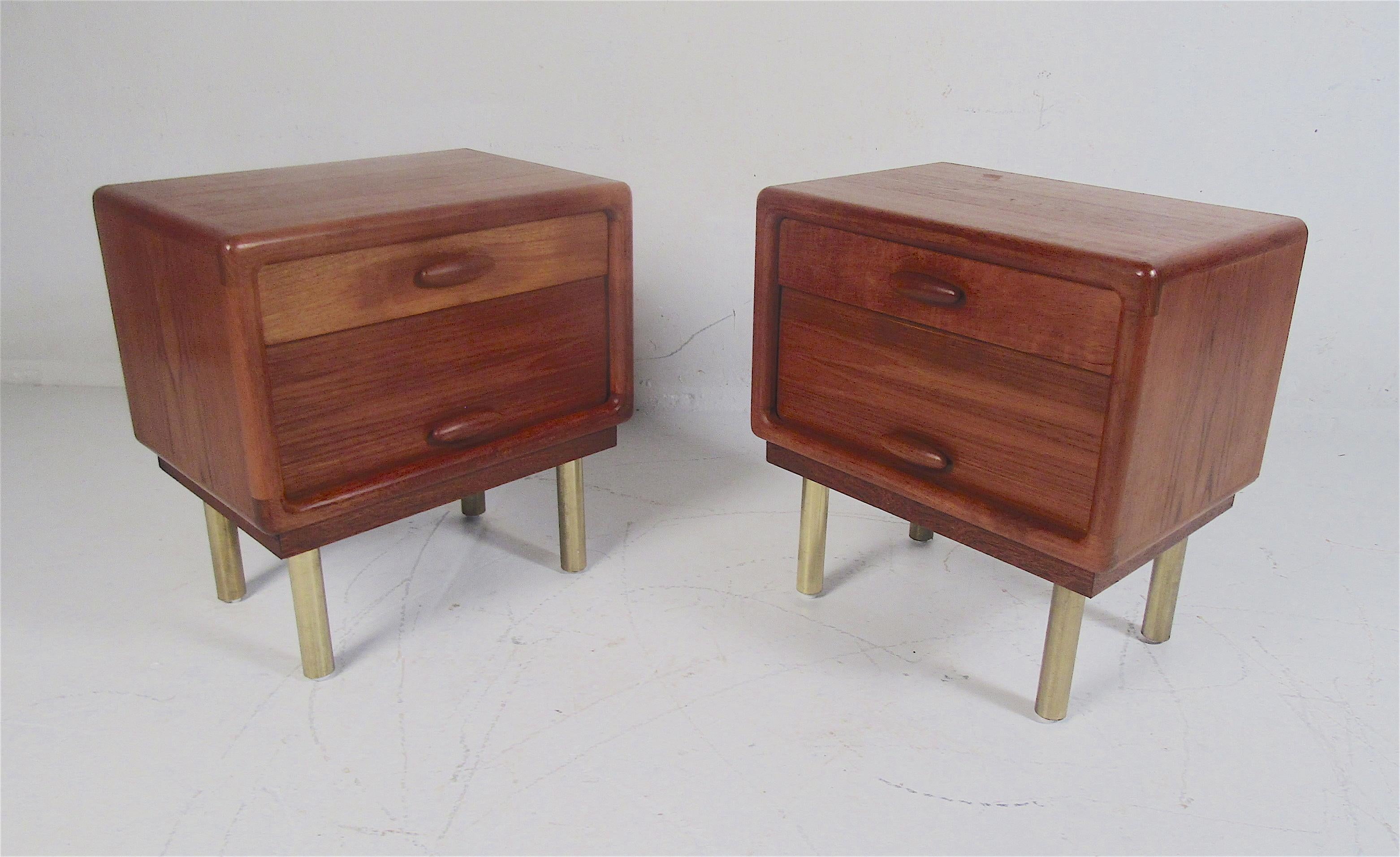 This stunning pair of vintage modern nightstands feature cylindrical metal legs and elegant teak wood grain. A unique design with one large drawer and a roll-up tambour door. The sculpted drawer pulls and semi-finished back show quality