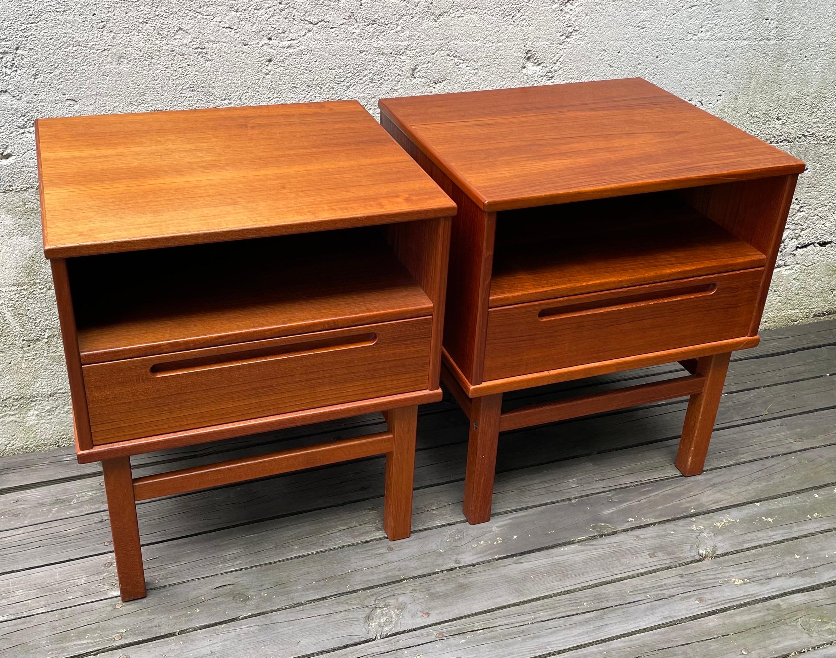 Beautiful pair of Mid Century teak night stands or side tables from Denmark. One drawer and one open shelf storage.