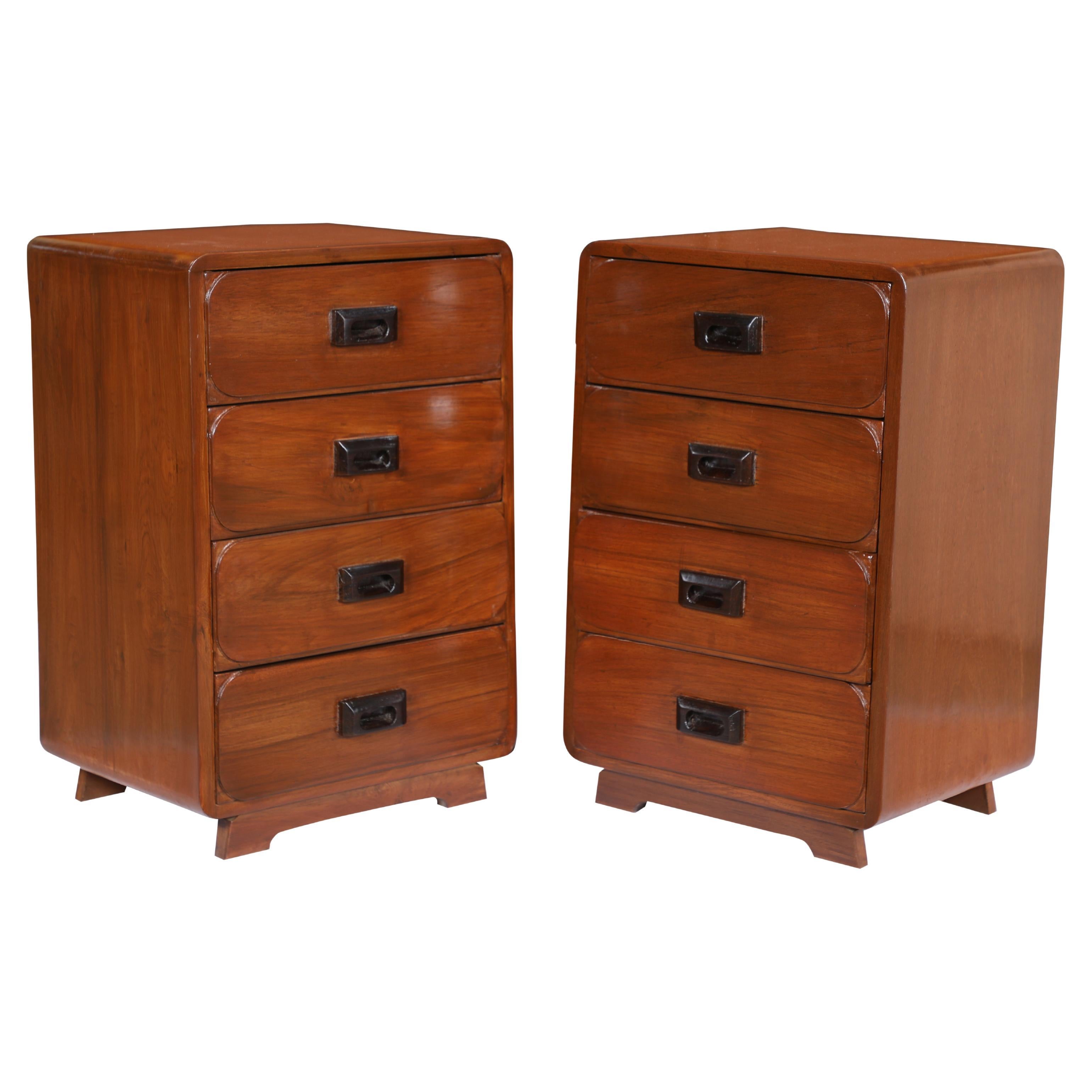 Pair of Mid-Century Modern teak side or end tables. Four drawers to a side with ebonized, recessed handles and curved drawer edges. Splayed feet. European, 1950's. Great to use as bedside tables or flanking either end of a sofa, with storage as