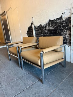 Pair of mid century modern thick chrome tube cube lounge chairs tan leather