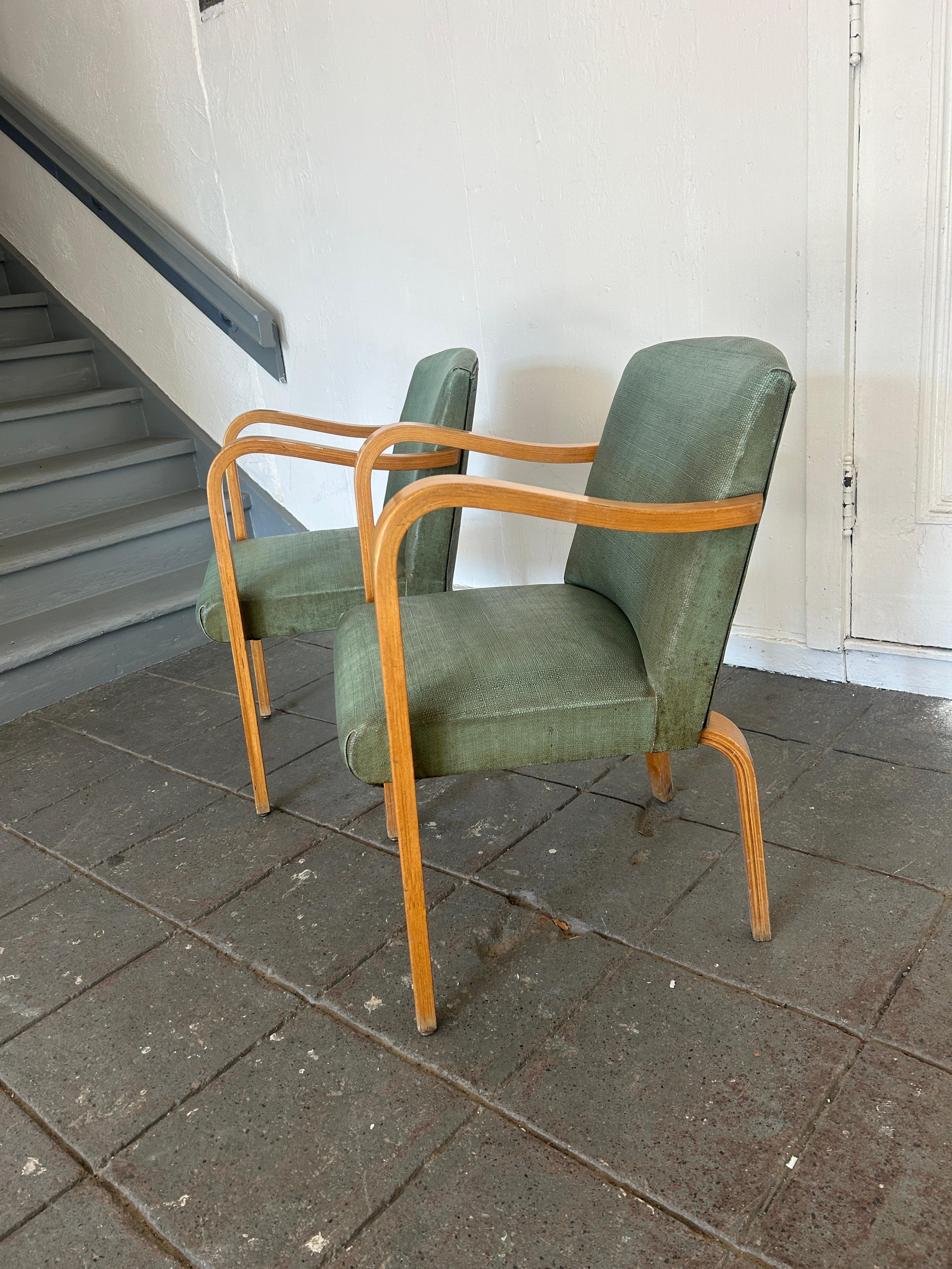 Pair of Mid-Century Modern Thonet bentwood birch arm chairs. Has original worn Light blue textured vinyl upholstery. Worn vintage condition very structural  - Need reupholstering. Timeless chair design by Thonet. Curved birch bentwood arms. Chairs