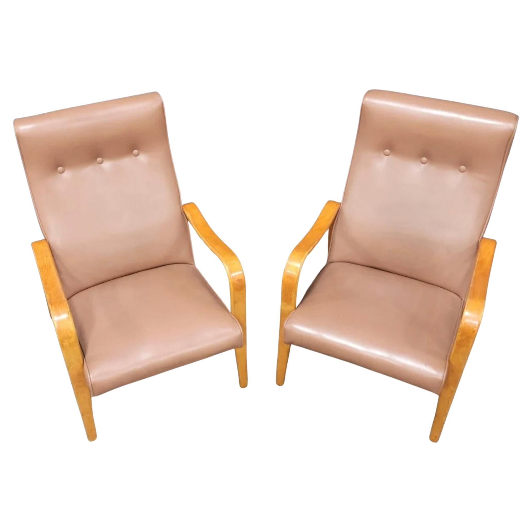 Pair of Mid-Century Modern Thonet bentwood birch lounge arm chairs. Has original medium pastel Rose color vinyl upholstery. Great vintage condition. Timeless chair design by Thonet. Curved birch bentwood arms. Chairs sold as a set of (2). Located in