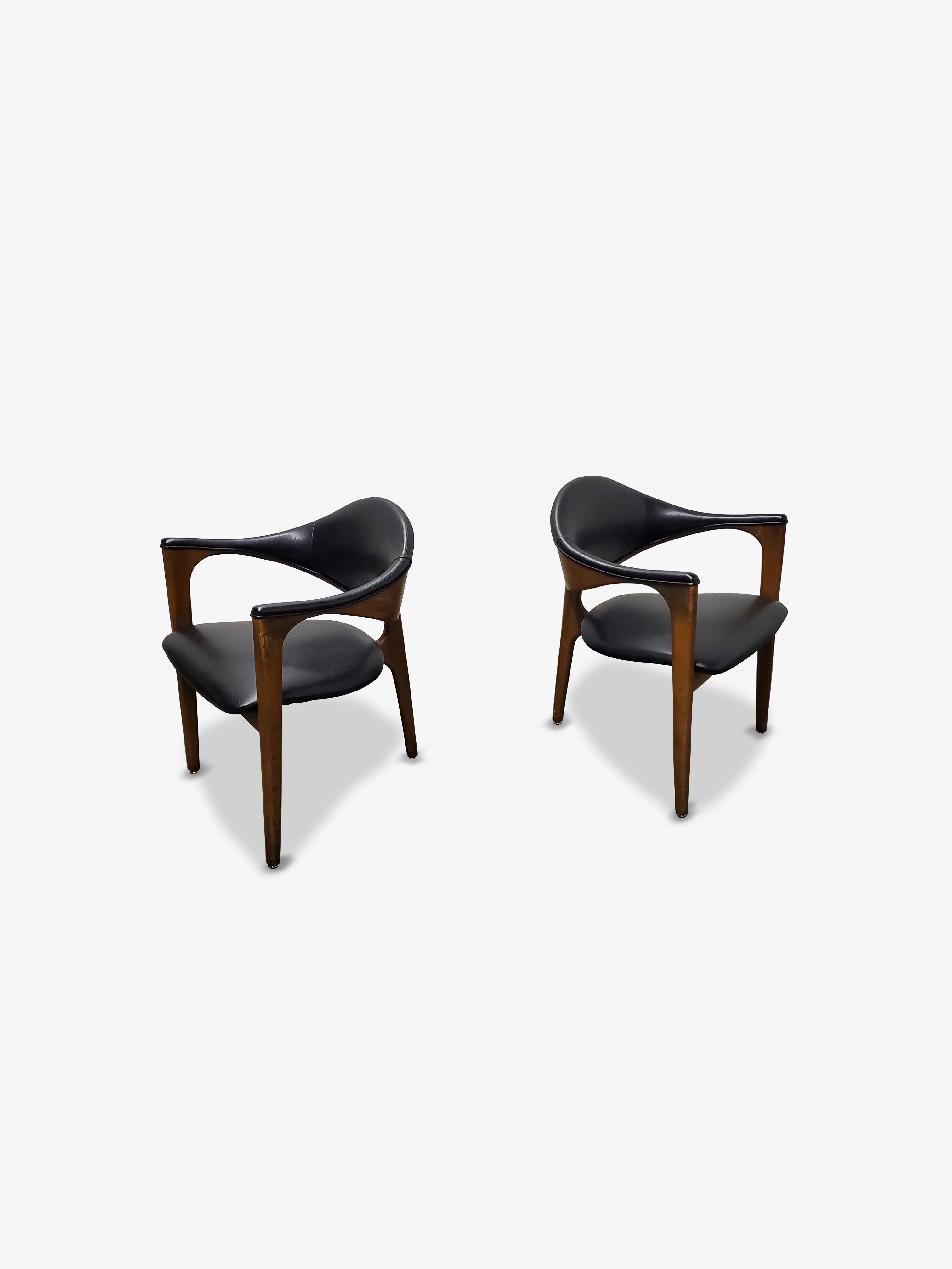 Pair of Mid-Century Modern three-legged chairs.