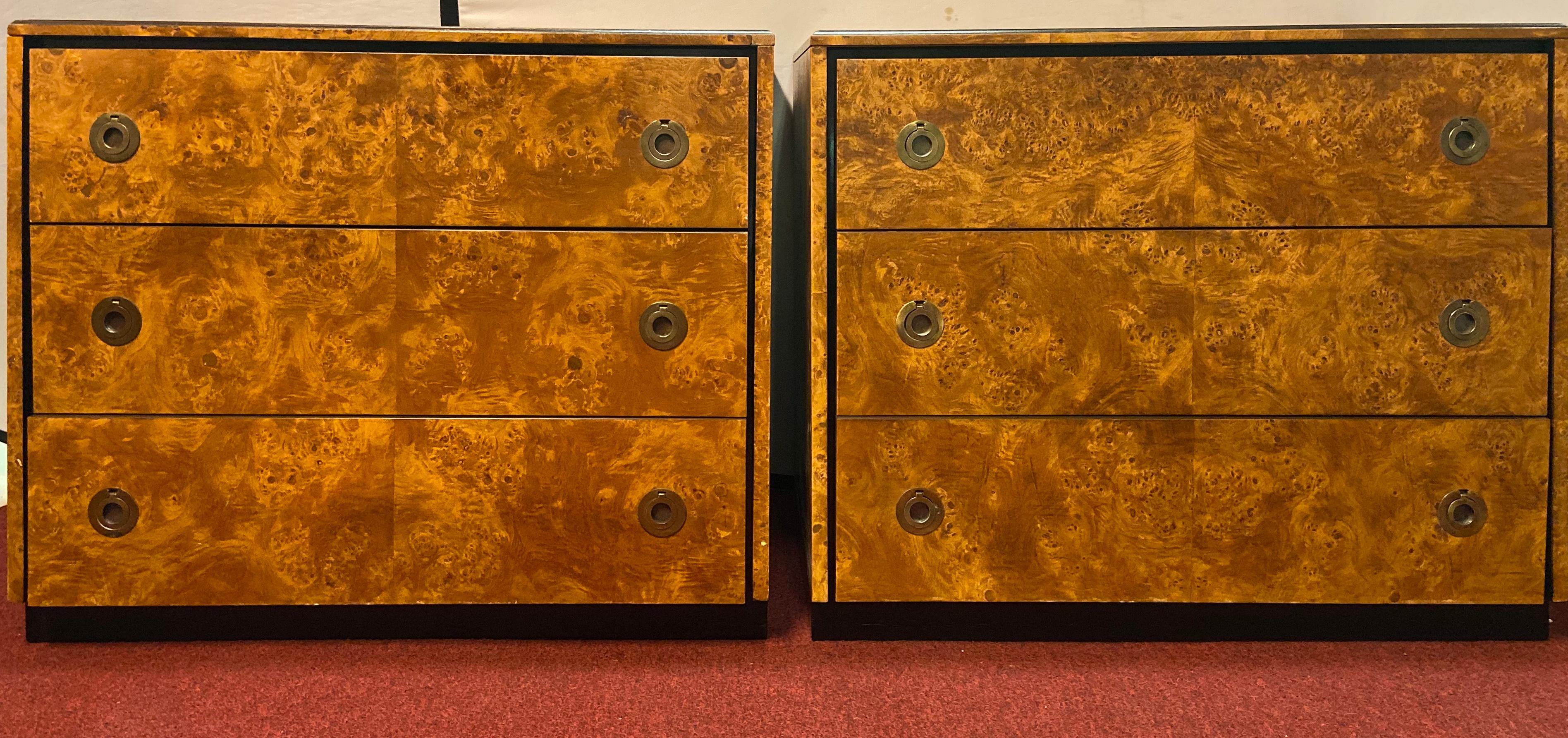 A timeless pair of Mid-Century Modern tortoise burl and ebony wood chests, commodes, or nightstands. Each commode features three drawers and gilt pulls. Each piece is labeled in the back. The pair is in great condition.