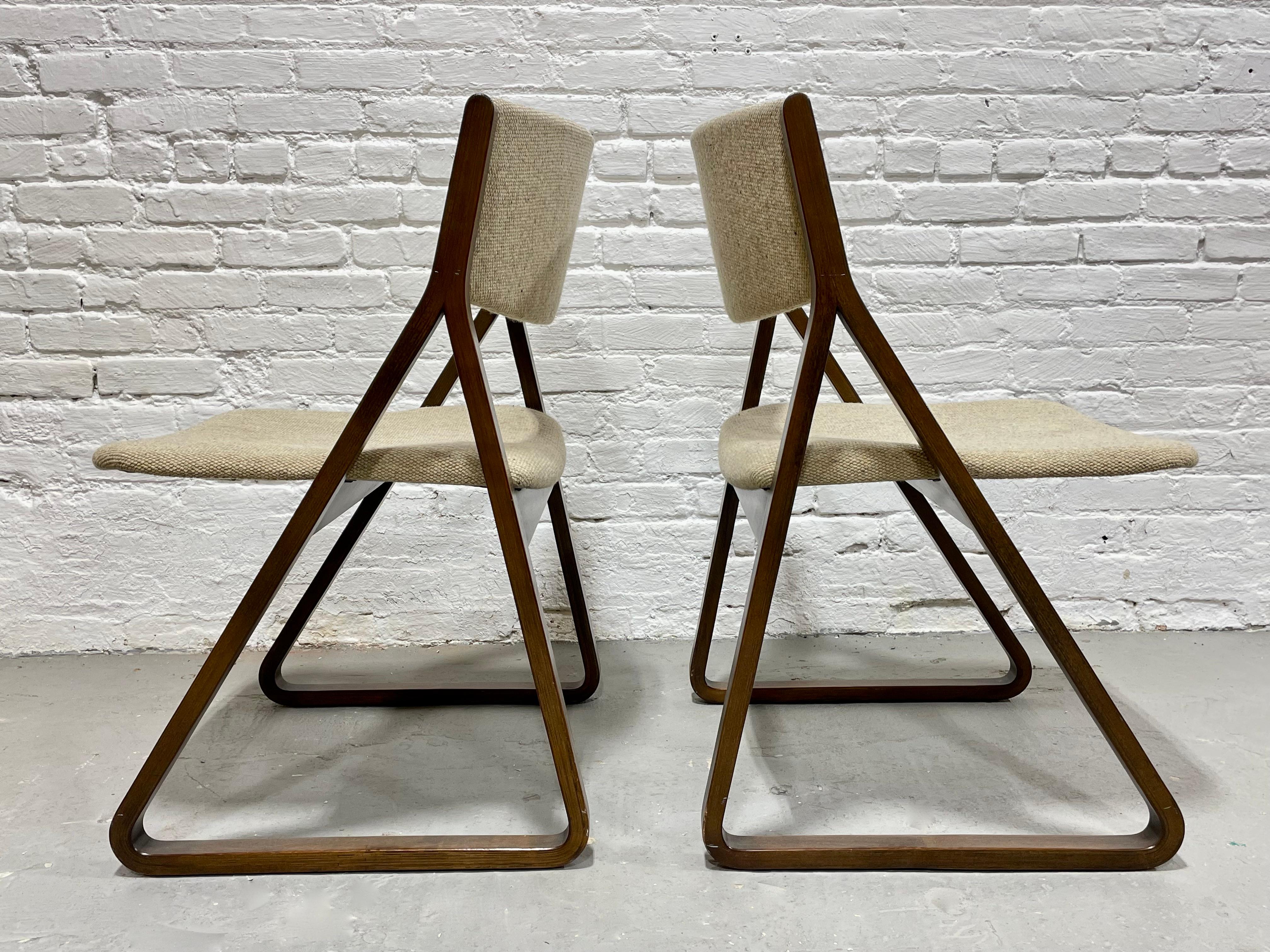 Pair of Rare Mid Century Modern “Triangle” Chairs designed by Robert DeFuccio for Stow Davis.  The triangular profile of the chairs is incredible and the oatmeal colored upholstery contrasts beautifully with the darker walnut frames. Lovely