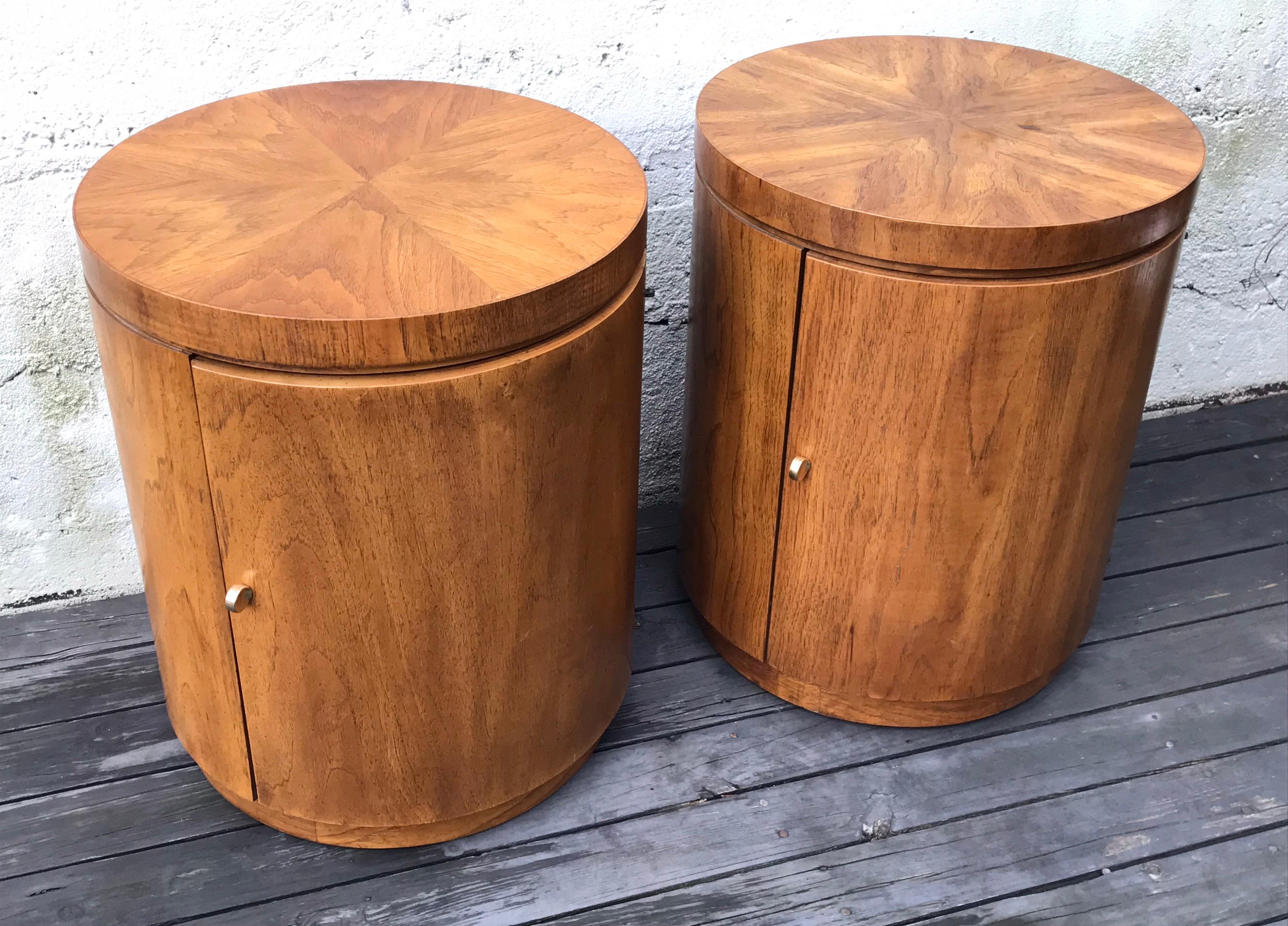Nice pair of mid century tubular round side tables by Drexel. Faux burled maple finish with brass door pulls.
Minor veneer loss at bottom edges and minor fading at one backside, please see photos.
