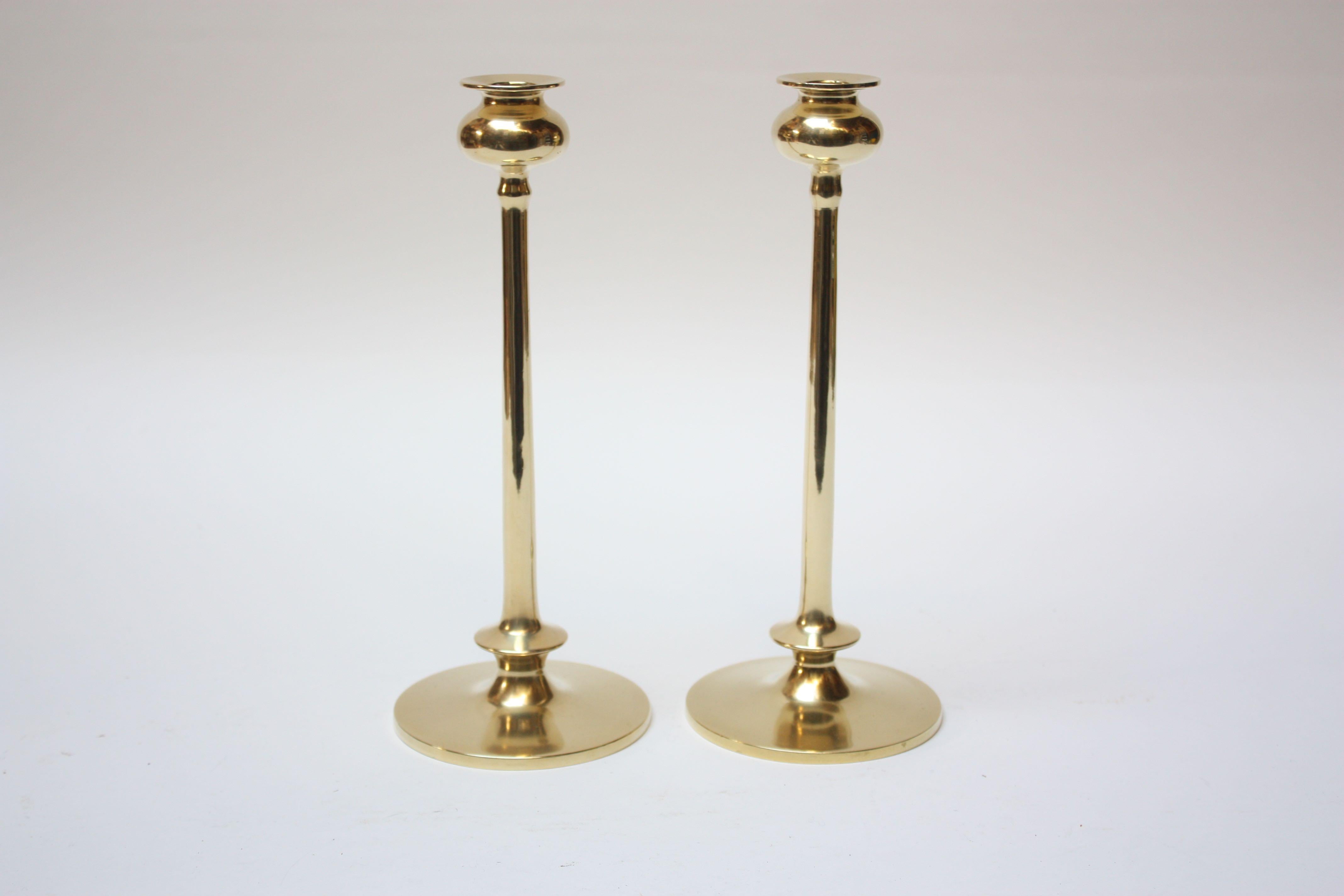 Midcentury brass turned candlesticks, each with bulbous bobeche and cylindrical stem on circular base,
Excellent, polished condition with only minor wear consistent with age and history.