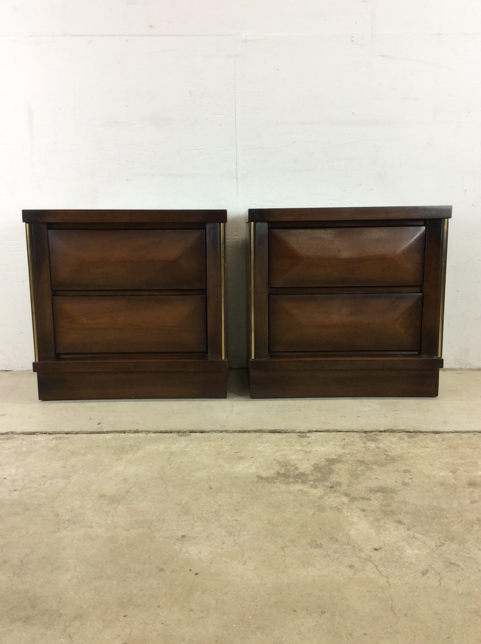 This pair of Mid-Century Modern nightstands feature hardwood construction, original walnut finish, two dovetailed drawers with beveled drawer faces and plinth bases.??Matching highboy dresser, queen headboard, and lowboy dresser available