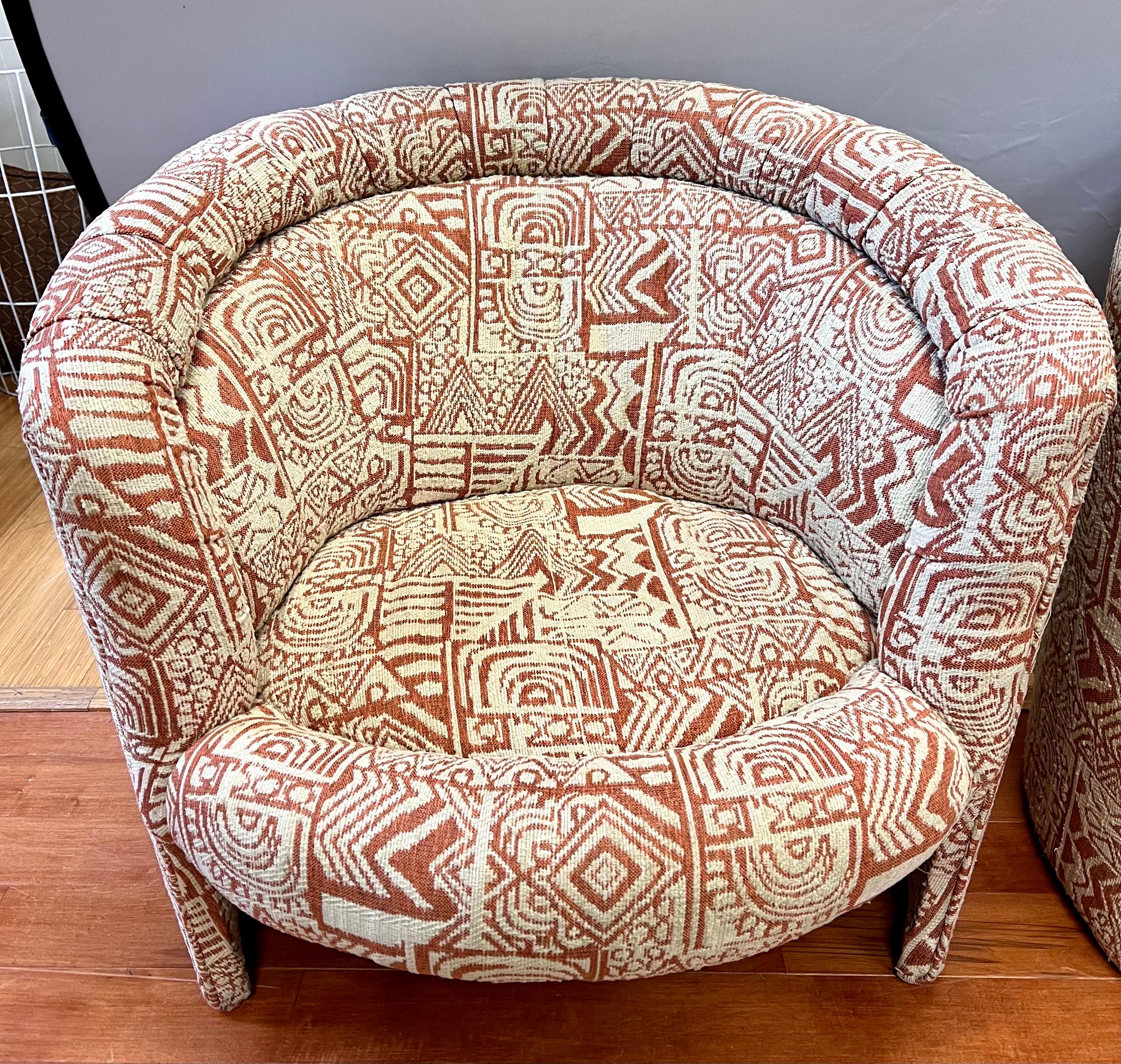 Pair of midcentury upholstered barrel back curved club or lounge chairs. The fabric is magnificent. Why not own the best?.