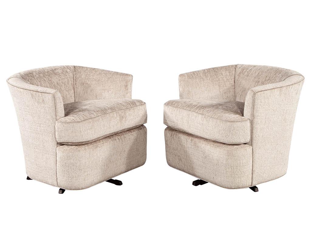 Pair of Mid-Century Modern upholstered swivel chairs. Newly upholstered in luxurious beige textured fabric with contrast piping. Comfortable thick seat cushion and swivel mechanism make these great for entertaining.

Price includes complimentary