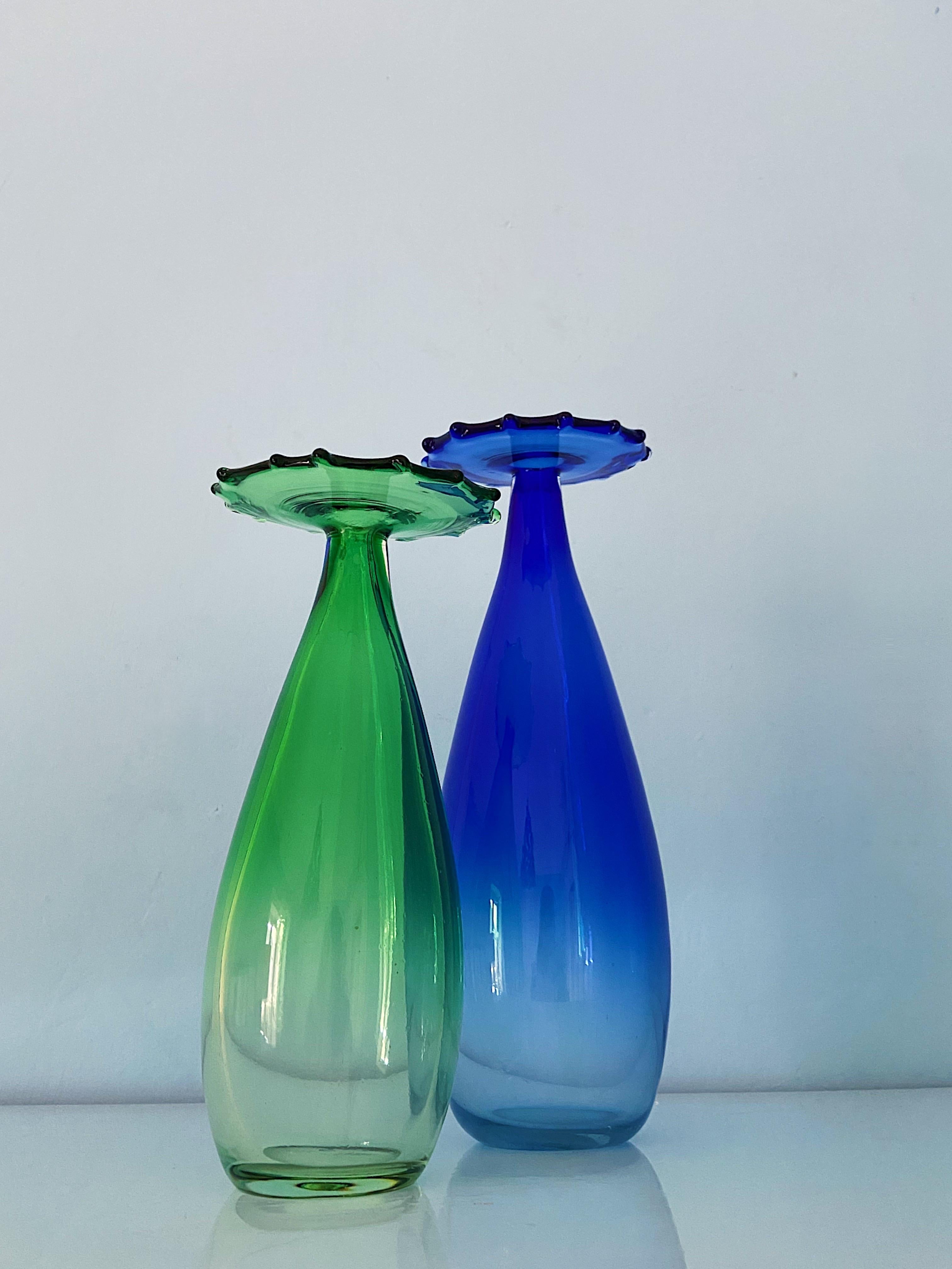 Pair of beautiful Murano glass vases signed La Murrina, 1970s.
Asymmetric base with a flower like top. The color graduates from transparent glass into strong green and blue color.
Both vases are signed in the glass. Sold as a