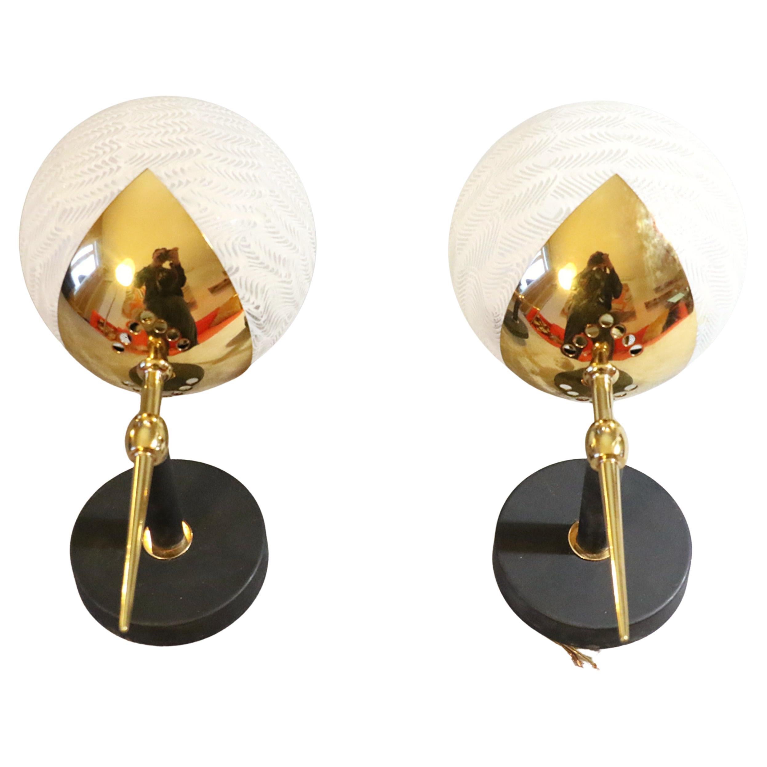 Pair of Mid-Century Modern Wall Sconces by Maison Arlus, France, 1950s

Stunning pair of wall sconces designed by Maison Arlus in the 1950s. These elegant fixtures feature a refined combination of materials: frosted glass globes with an intricate