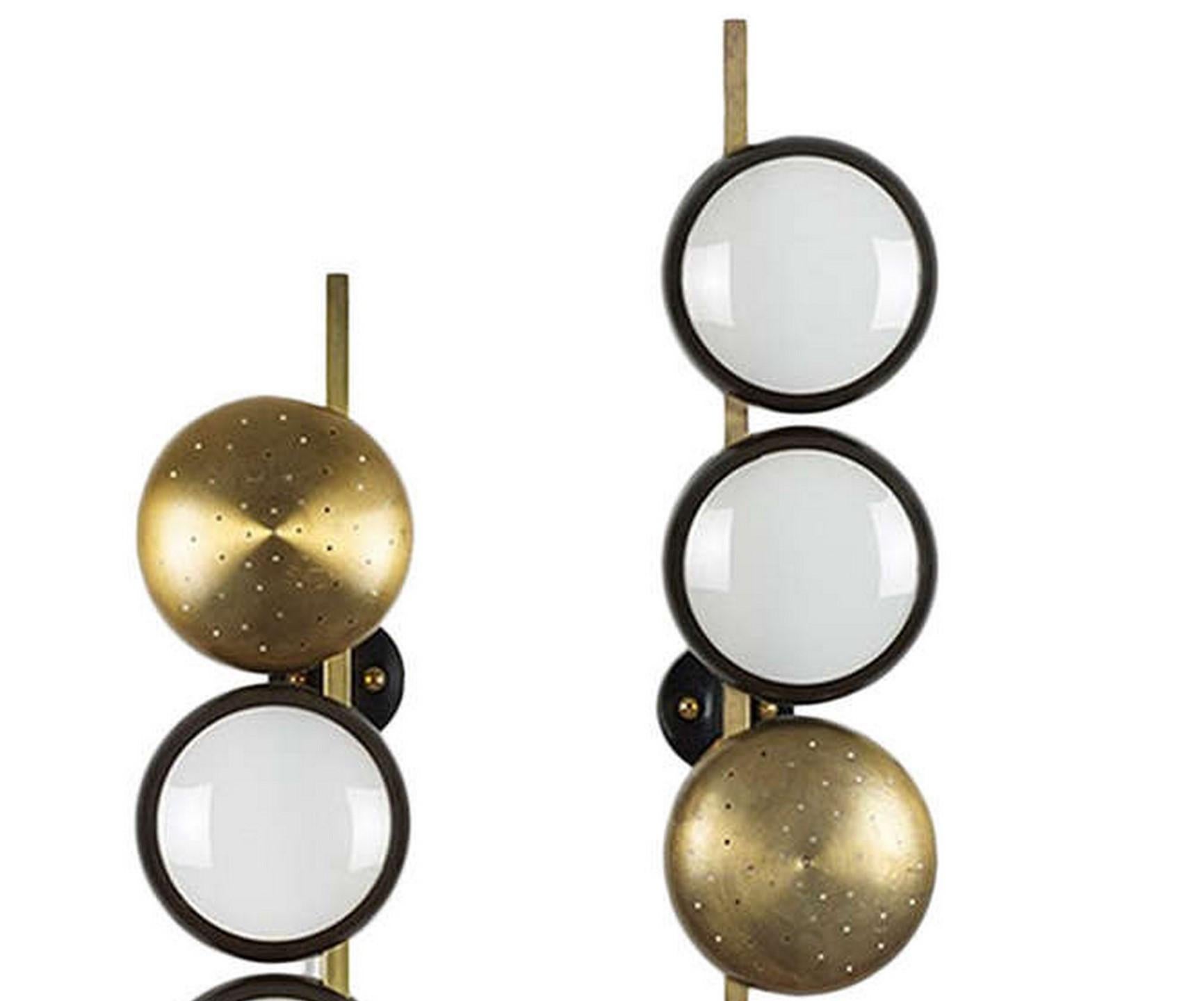 Pair of rare elegant well sized wallights Model 579 designed by the well known designer Oscar Torlasco and produced by Lumi. They have one reflector in brass per wallight with pierced holes to reflect light and the other two reflectors have bronzed