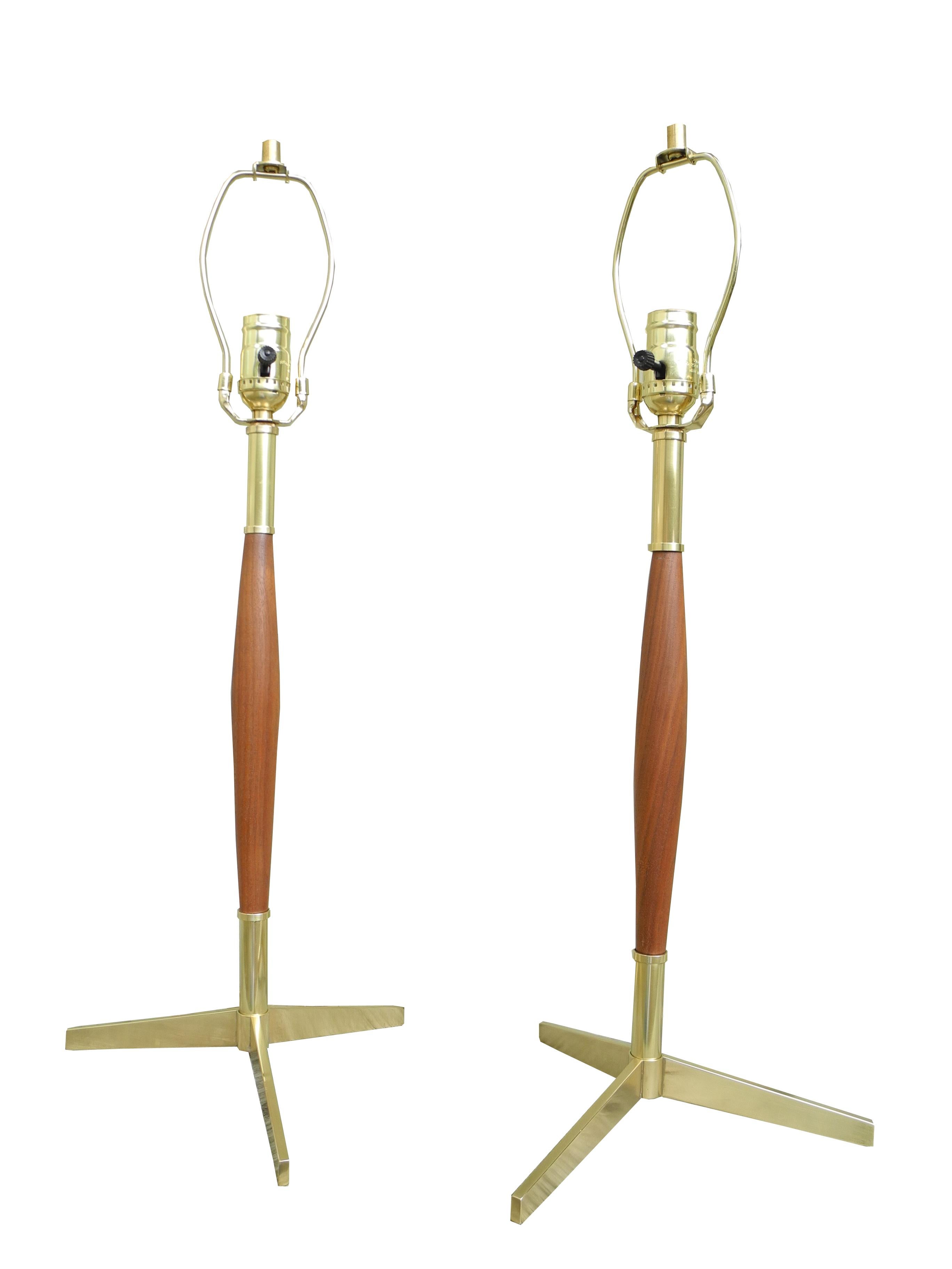 These walnut and brass table lamps were designed by Gerald Thurston in the 1950s. Perfect bedside lamps.
