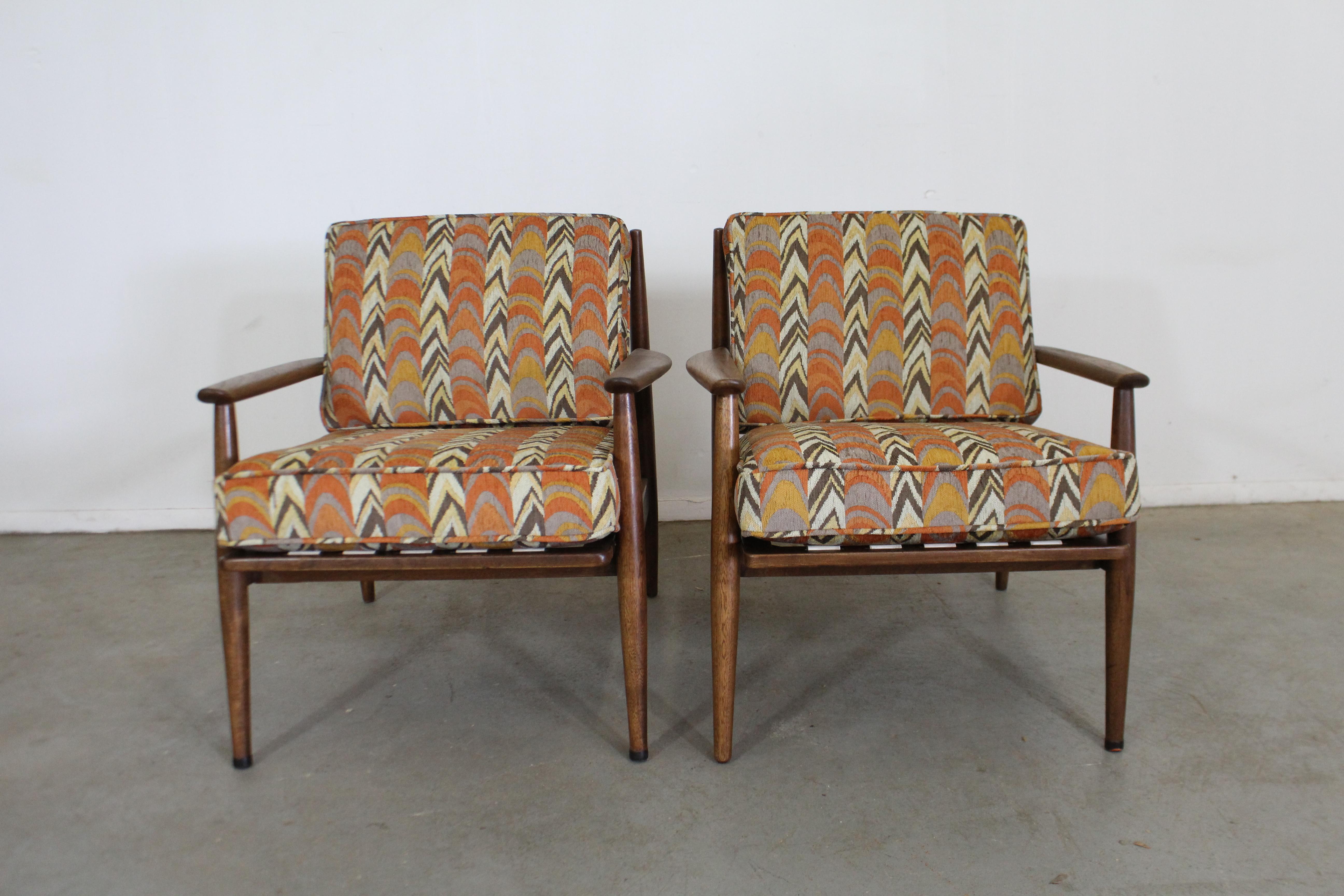 This set includes a pair of Mid-Century Modern walnut lounge chairs. They have been refinished and reupholstered with new period correct Directional fabric. They are in excellent condition, with minor wear (refinished, reupholstered, minor