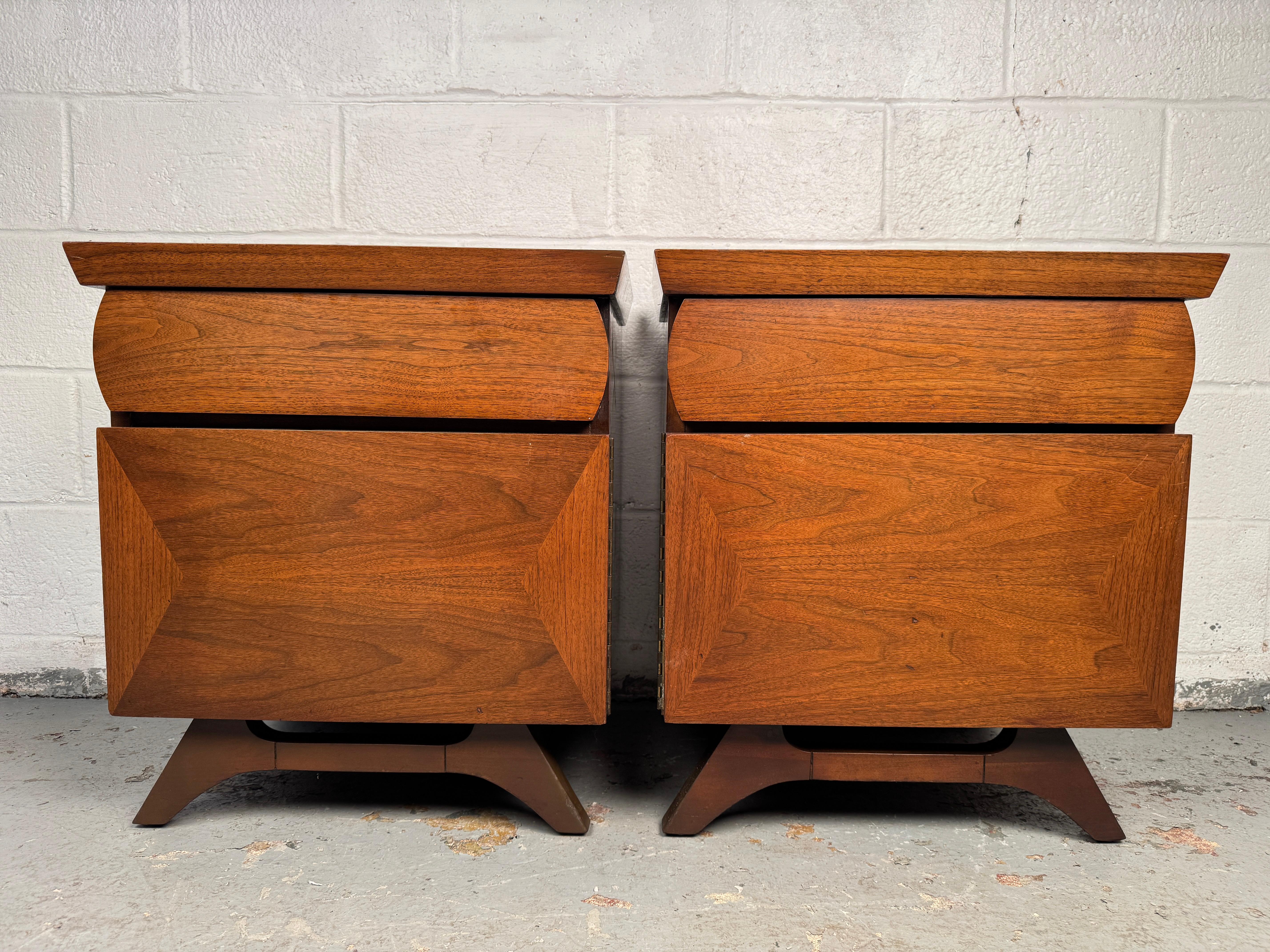 Handsome pair of mid-century nightstands crafted in solid walnut, showcasing warm grain and clean modern lines. Each offers practical storage with drawers and a compact footprint, making them versatile as bedside tables or end tables. A refined