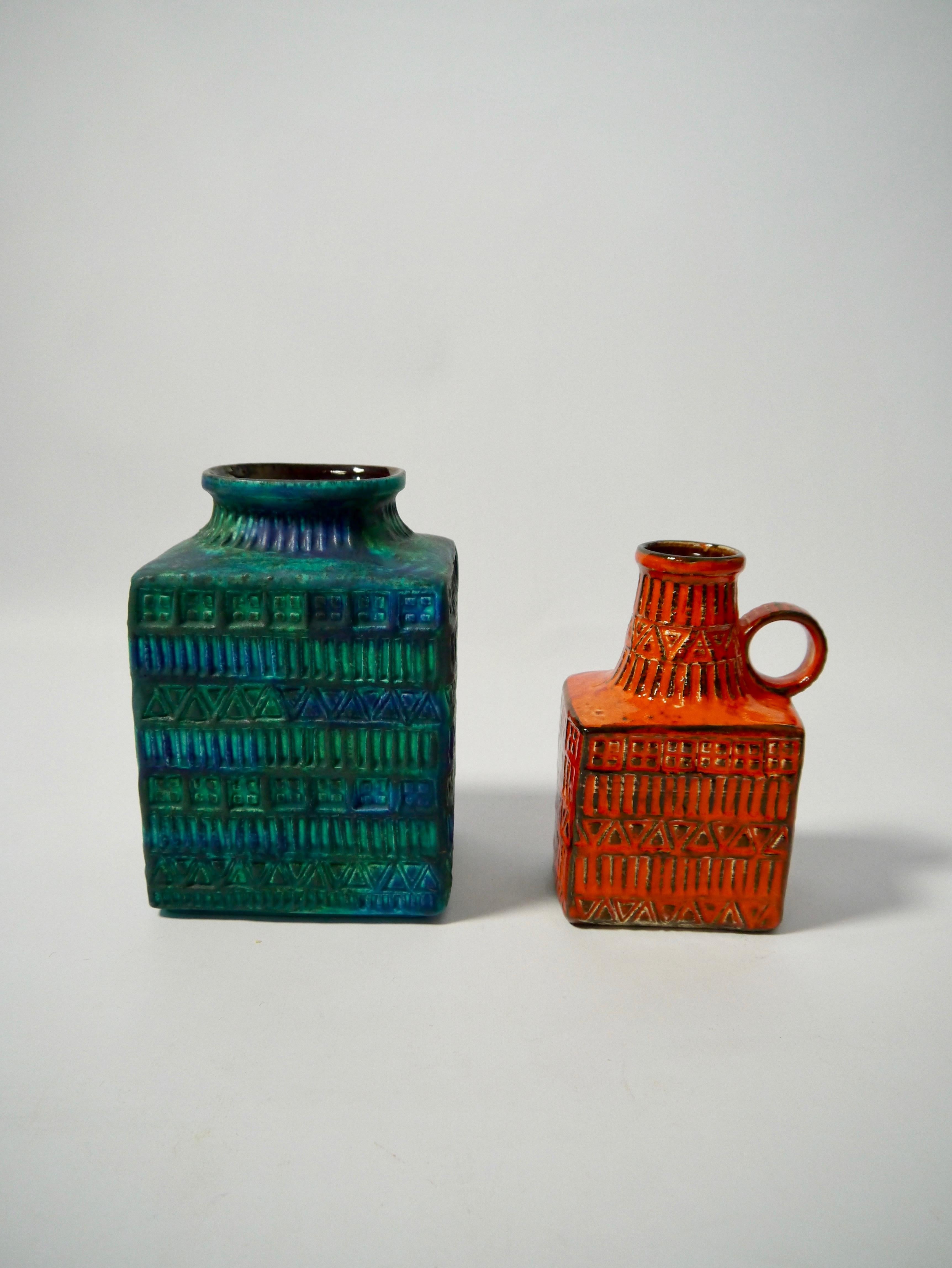 Pair of Mid-Century Modern glazed ceramic vases designed by Bodo Mans for BAY Keramik, West Germany, 1960s. Decorative geometric pattern and vibrant shades of orange and blue and green. 

 