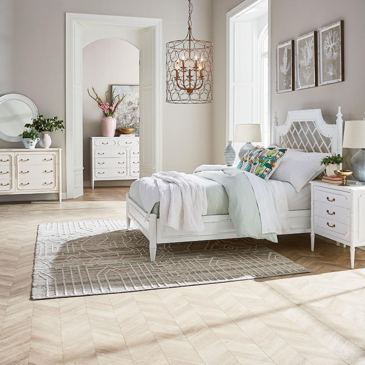 Influenced by the English Regency period, this exquisite piece features a sleek, lightly distressed architectural white-painted finish that effortlessly brightens any room. Its elegant faux bamboo design brings a touch of nature-inspired charm,