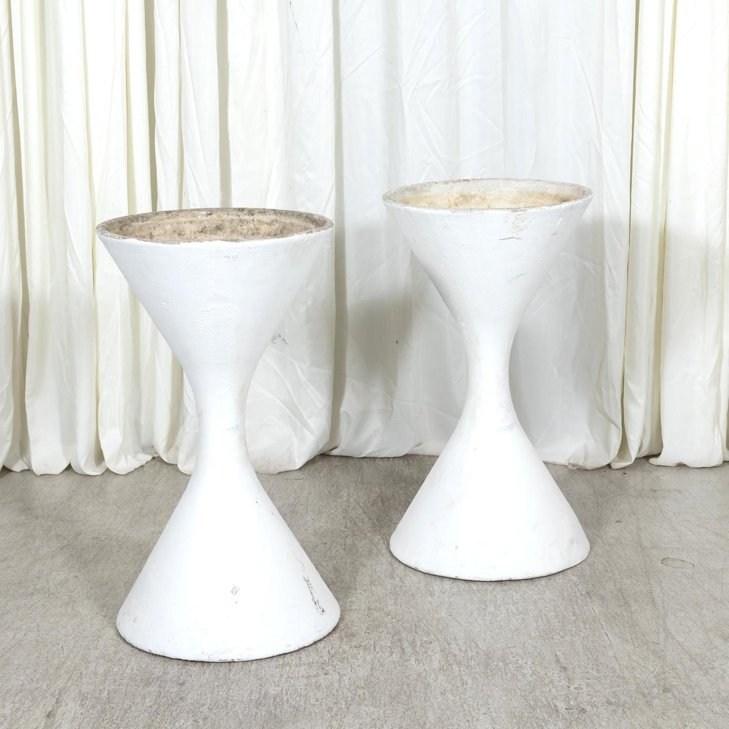 A pair of X-large Mid-Century Modern Diabolo planters designed by Swiss architect Willy Guhl for Eternit, circa 1960s. Originally made in three sizes, this pair is the X-large size at 37 inches tall. Solid and hefty, these iconic sculptural