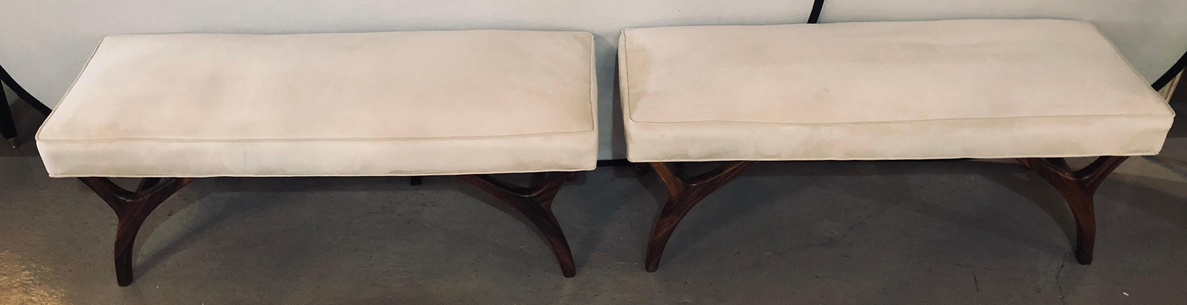 Pair of Mid-Century Modern window benches or stools in an new upholstery with new welts and springs. The fine rosewood like carved legs supporting a comfortable and recently upholstered seat.