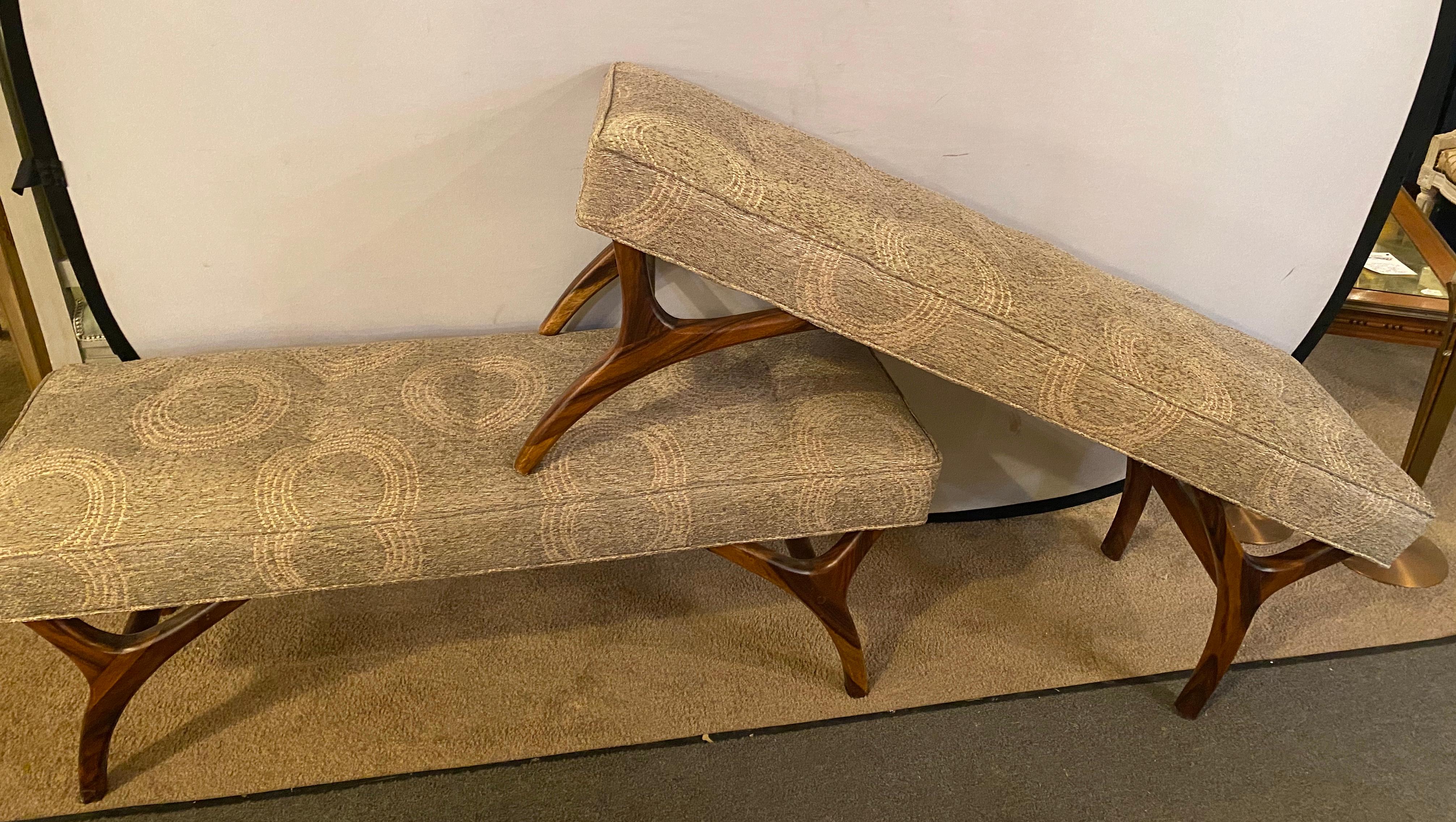 Pair of Mid-Century Modern window benches or stools in a new upholstery with new welts and springs. The fine rosewood like carved legs supporting a comfortable and recently upholstered seat.