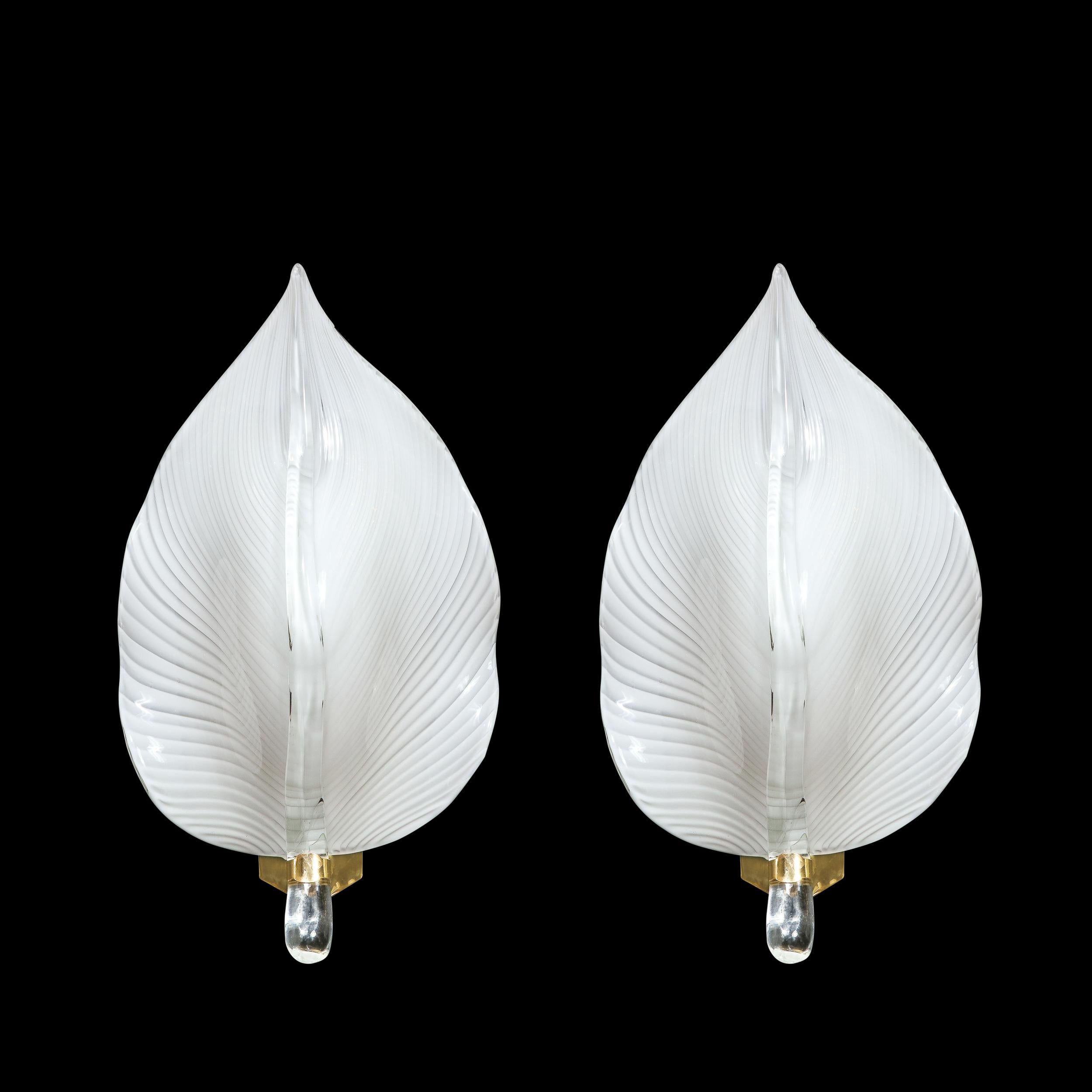 This Elegant Pair of Mid-Century Modenist Hand-Blown Murano Glass Leaf Sconces are created by the esteemed Murano Glass Artist Franco Luce and originate from Italy, Circa 1970. Highly elegant and deeply grounded in observation of nature, these