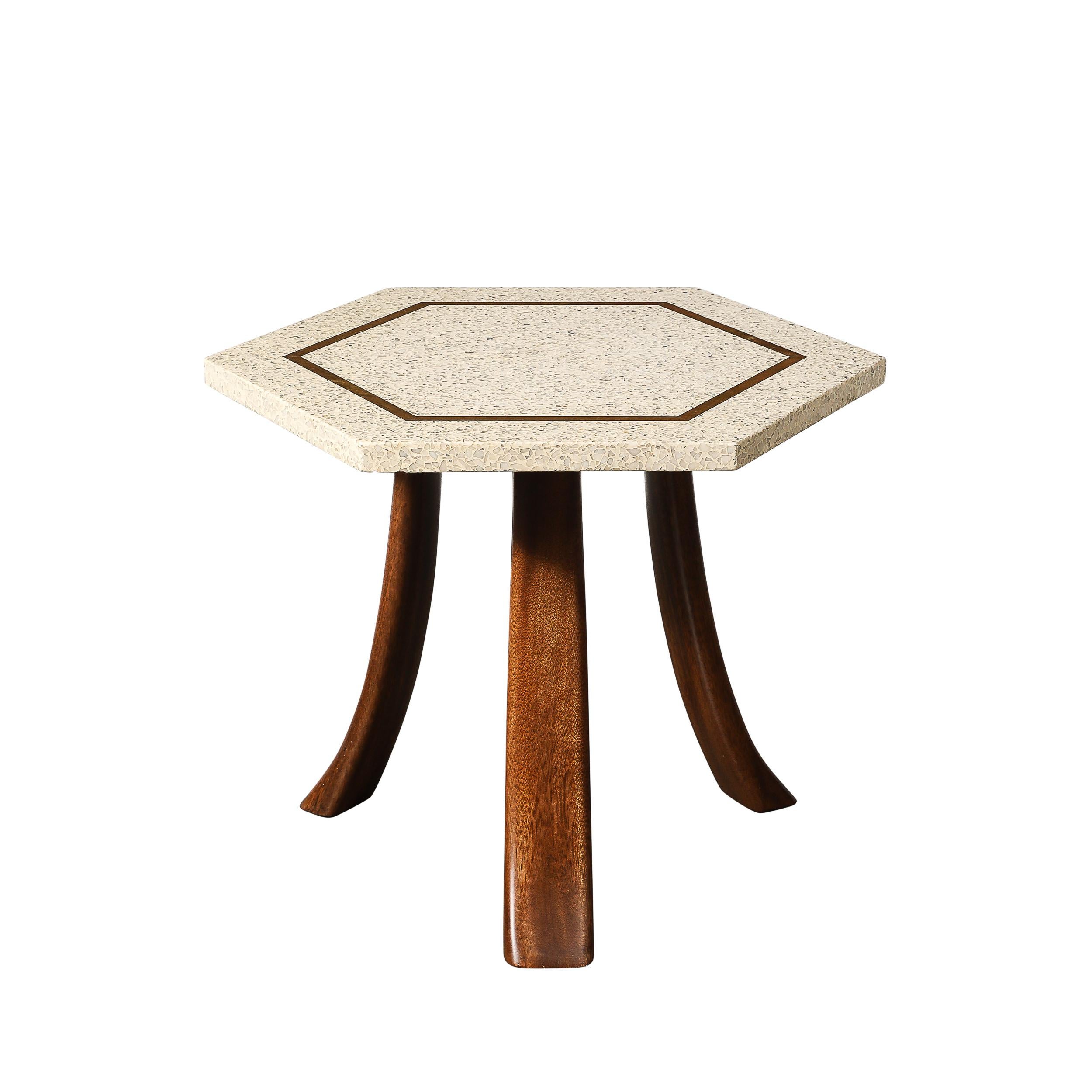 This unique Pair of Three Mid-Century Modernist Hexagonal Terrazzo Side Tables W/ Brass Inlays & Curved Walnut Supports by Harvey Probber originates from the United States, Circa 1950. Each table features a hexagonal terrazzo top in an ivory hue,