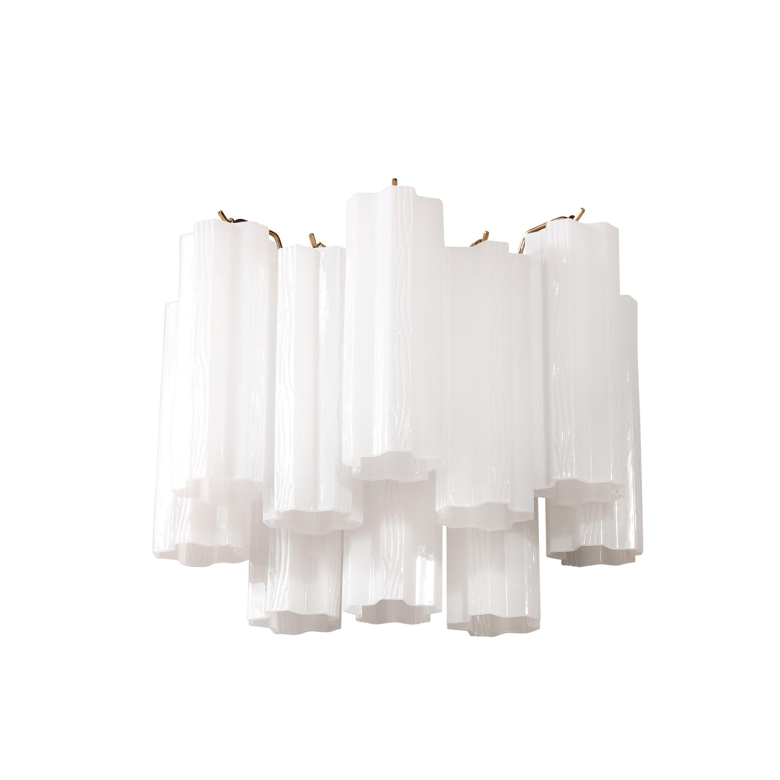This pair of sconces originates from the United States circa 1980. Featuring two tears of Tronchi form, opaline, glass shades which hang from a polished brass frame. The opacity of the opaline hue, beautifully diffuses light creating elegant