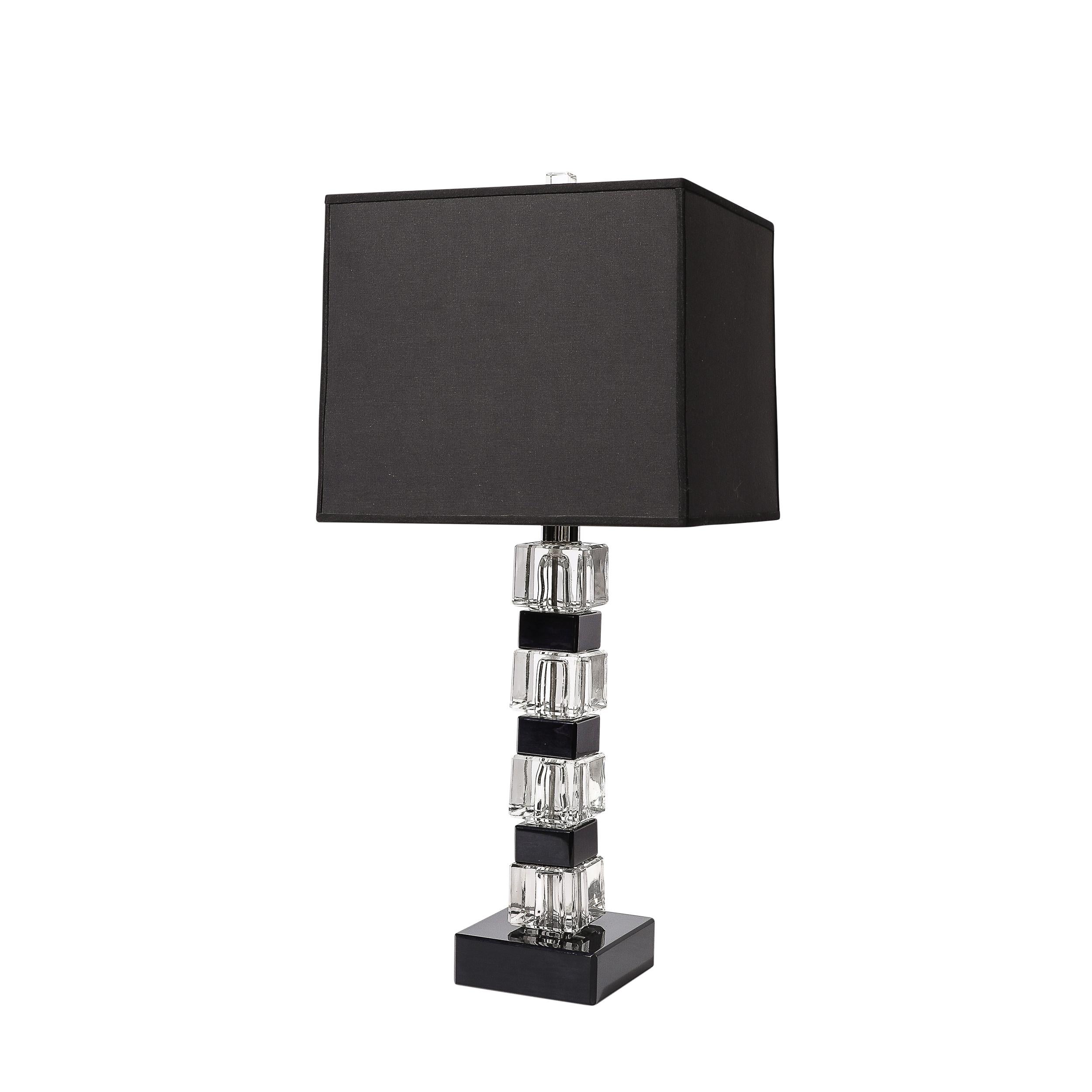This sleek and geometric pair of Mid-Century Modernist Stacked Black Lacquer and Glass Cube Table Lamps originates from the United States, Circa 1970. Features a stacked vertical design of alternating glass and black lacquered cubic elements with