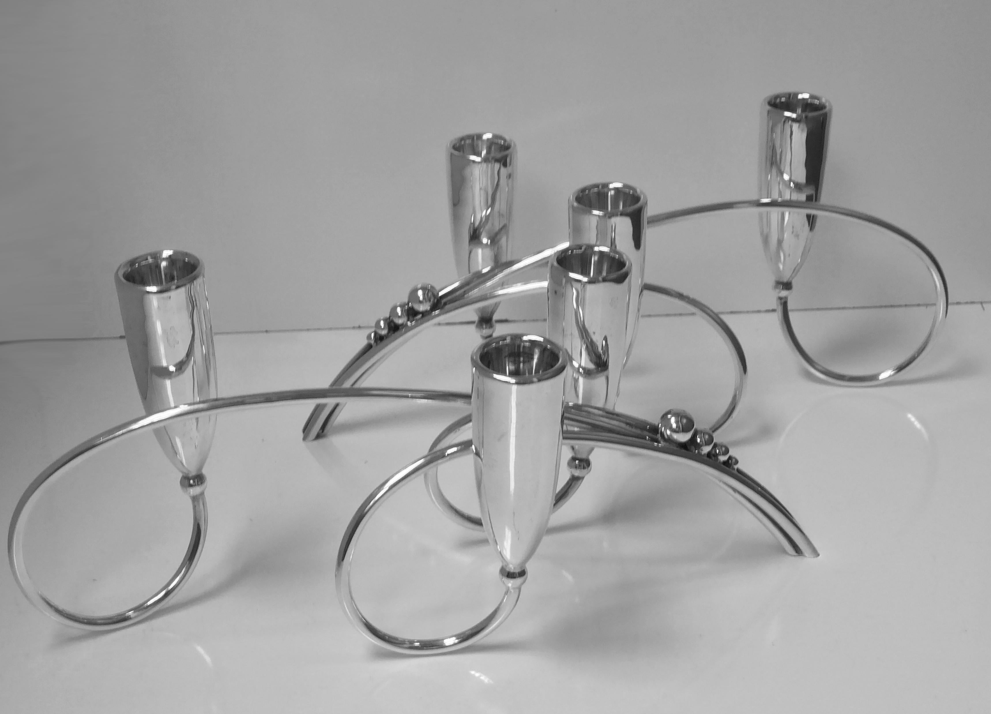 Pair of Mid-Century Modernist Aceves sterling candelabra candlesticks, Mexico, circa 1950. Each of a stylized curvilinear and blossom Scandinavian Jensen style, with three vase tulip shape candle holders in each candelabrum. Marked for Tango Aceves