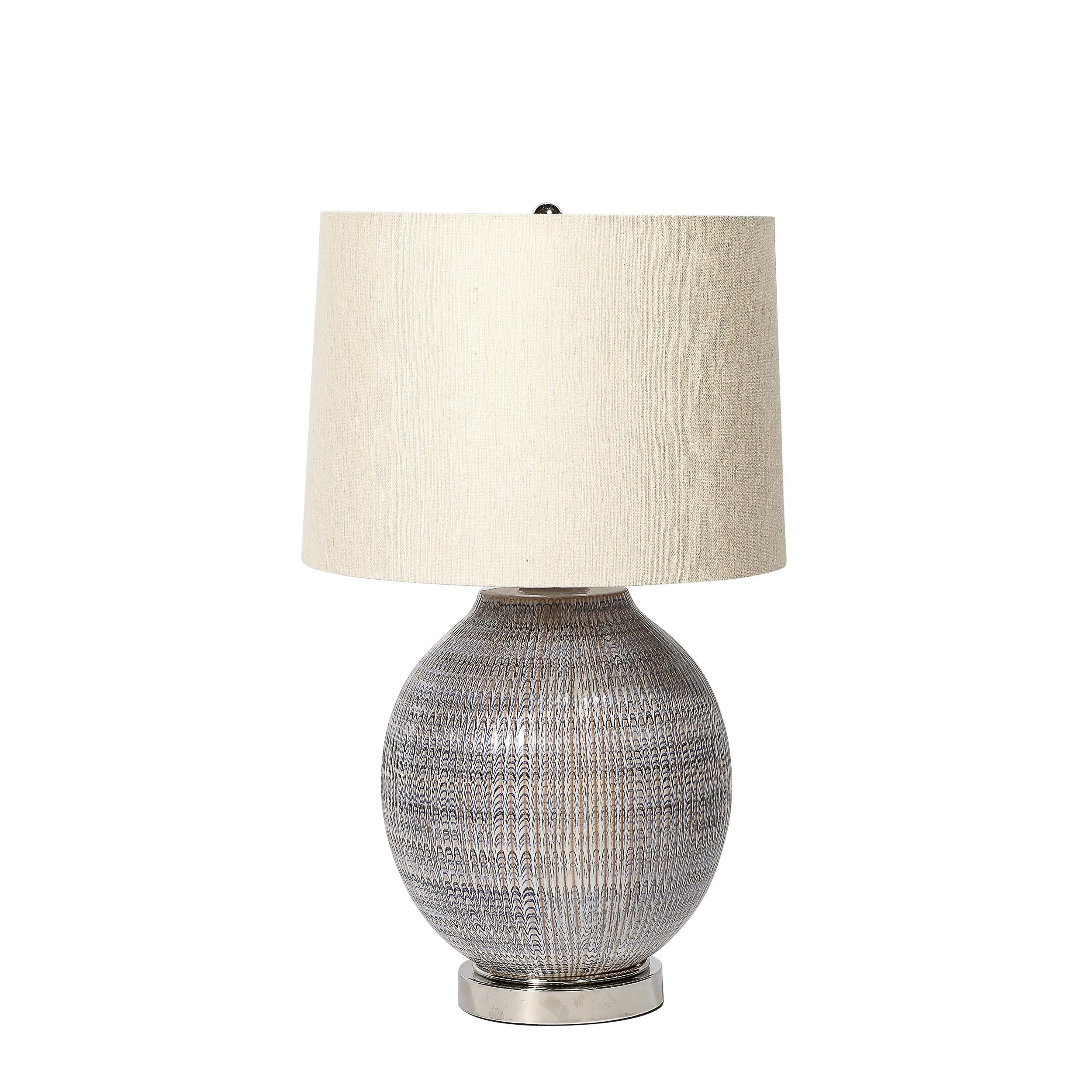 This materially balanced and well formed Pair of Mid-Century Modernist Striated Glazed Ceramic Table Lamps Originates from the United States, Circa 1960. Features a round base with a finish in striated ceramic glazing, a balance of colors that read