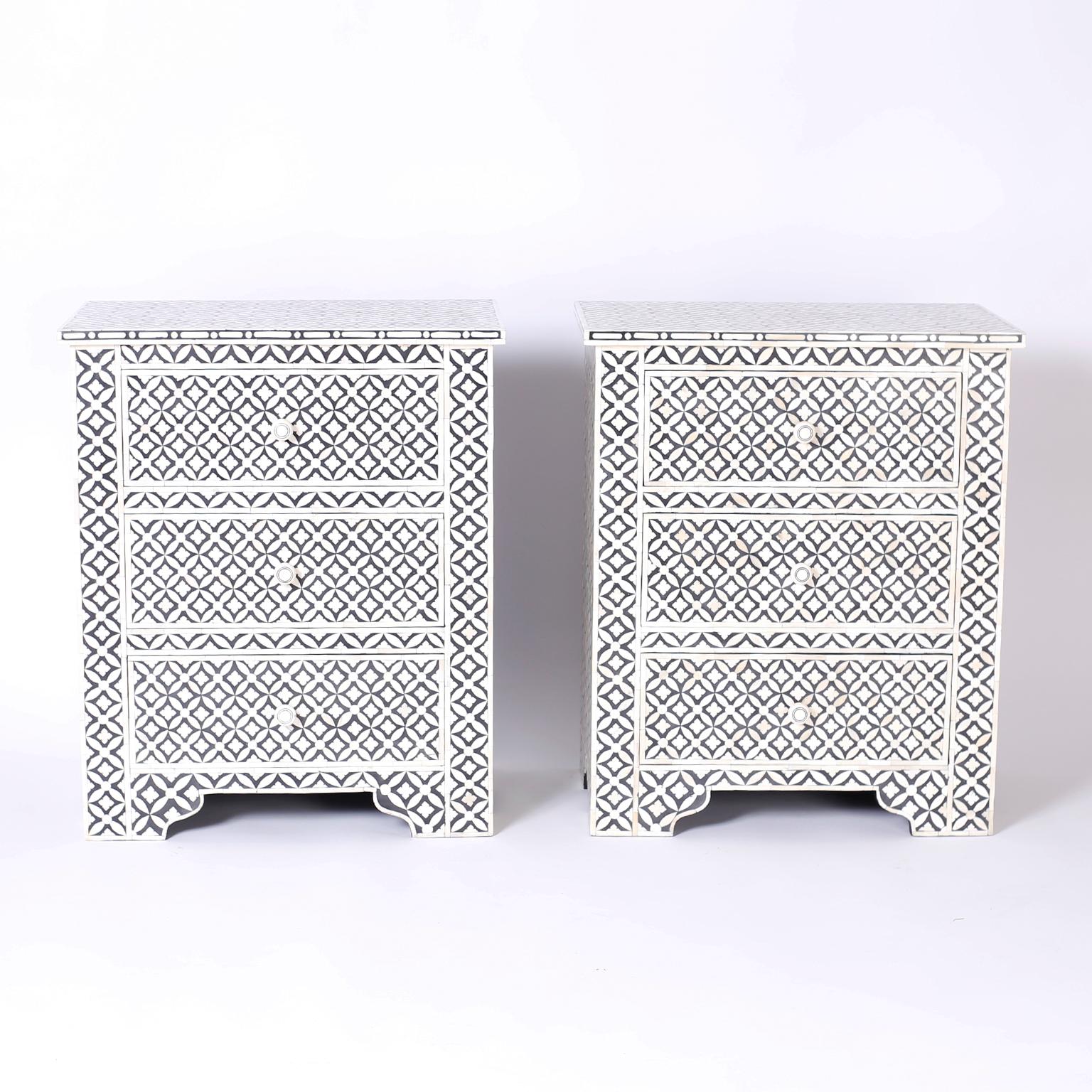 Pair of Moorish style three-drawer nightstands covered in bone mosaics with Classic form on bracket feet.