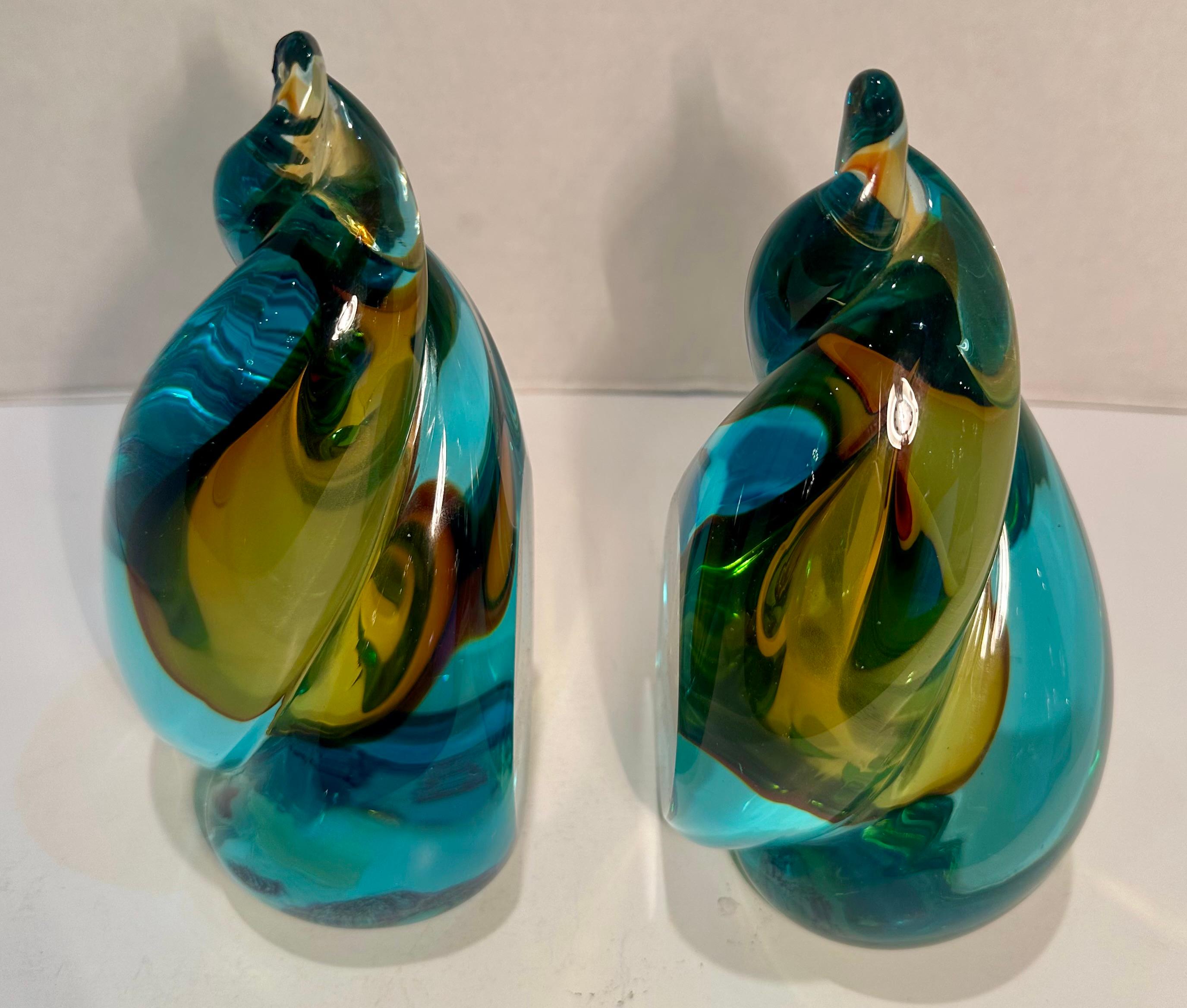 Very striking pair of hand made and mouth blown in Italy, Murano art glass sommerso twist motif bookends in a vibrant shade of aqua blue color with rich golden center.  The word 
