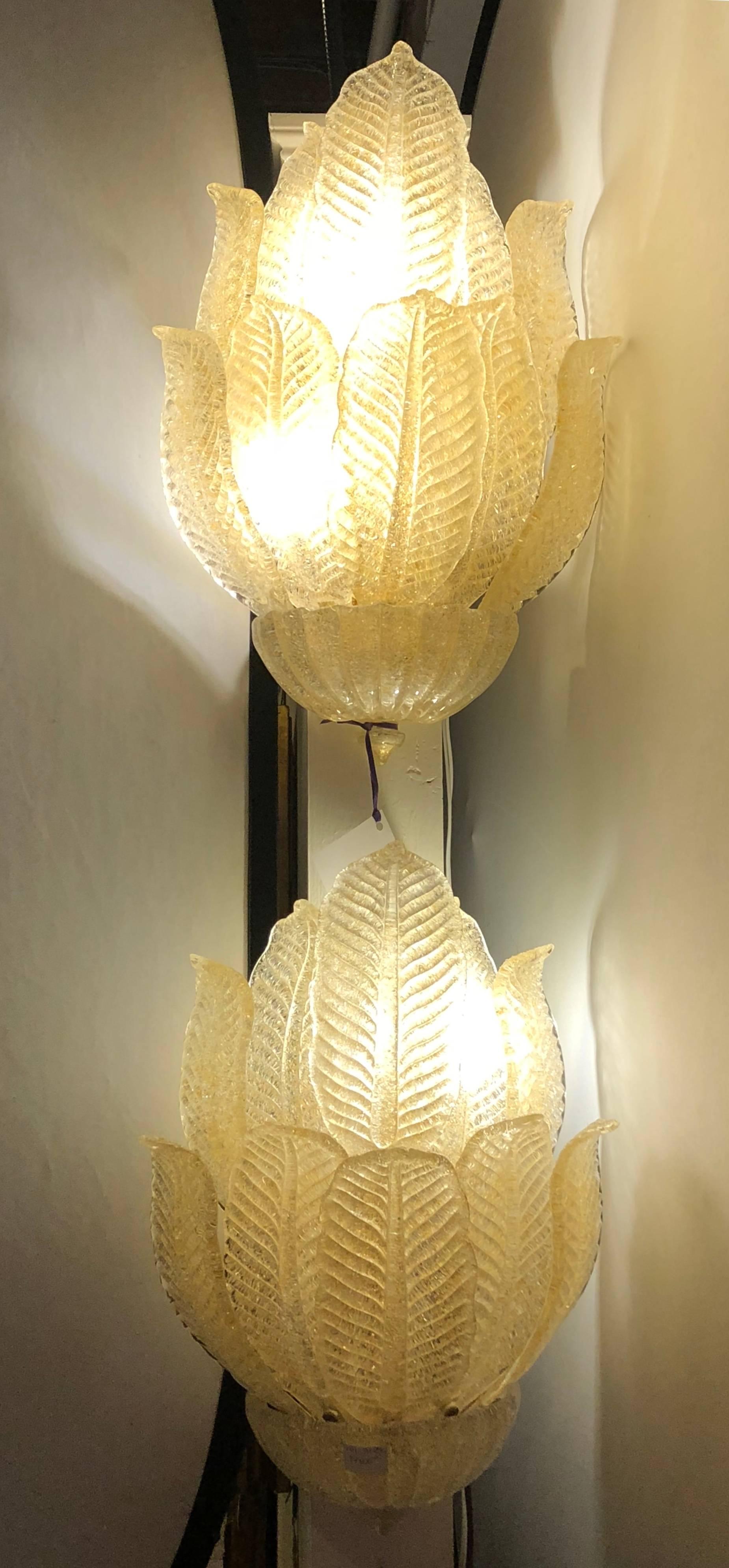 A Pair Of Murano Glass Barovier and Toso Four Light Leaf Design Wall Sconces. Each Sconce supported by a solid brass wall mount fixture taking four forty watt lights. The bottom Murano glass bowl having a group of ten large leaf form arms each of