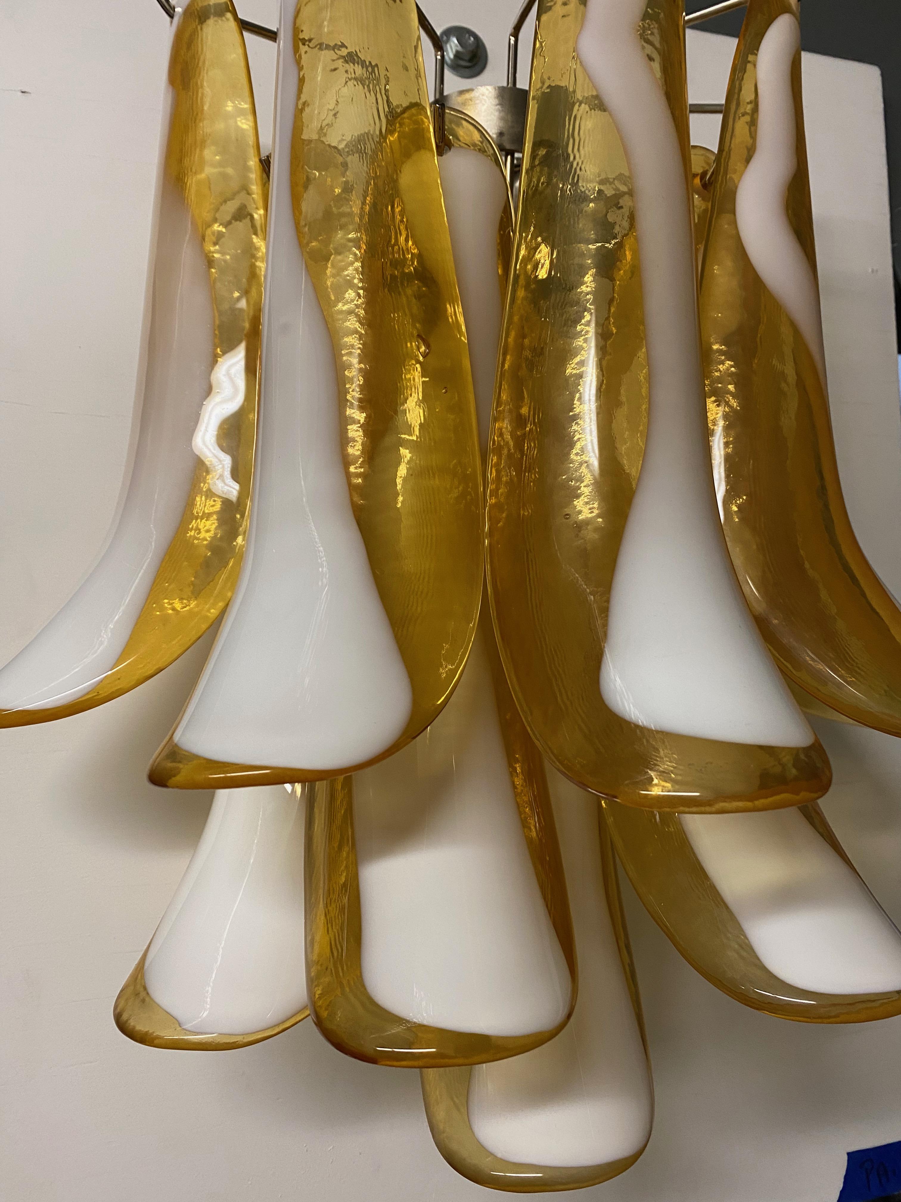 Pair of Mid century Murano wall sconces. Having gold and white Murano glass hanging from a nickel frame, as pictured. Has been Rewired for American use.
 